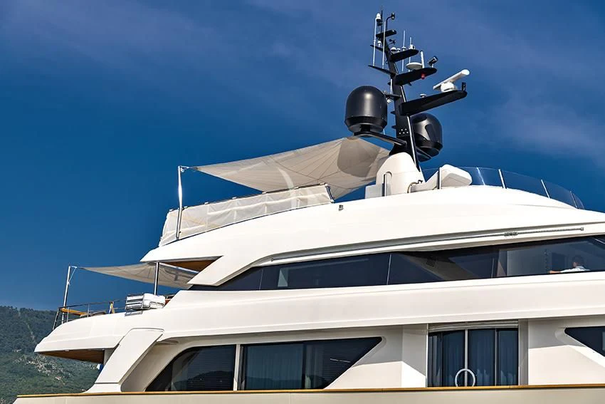 a white yacht with a satellite dish on top aboard ANYTHING GOES V Yacht for Sale