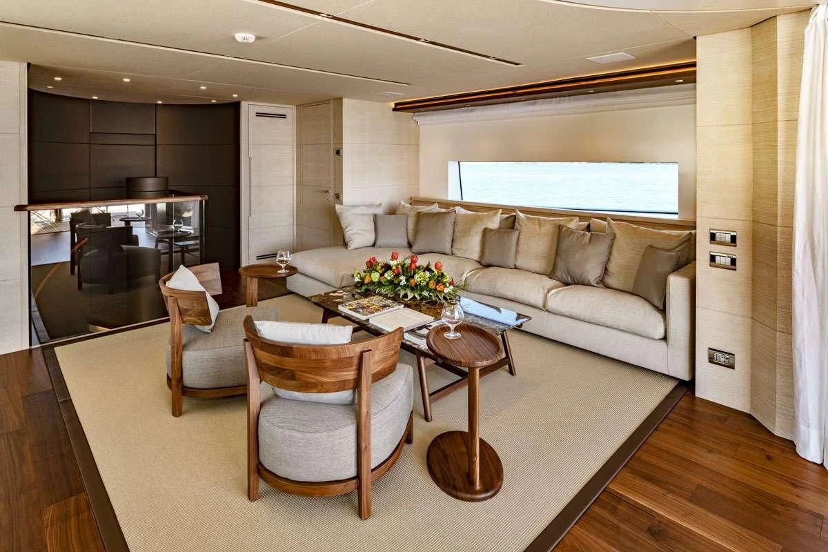 a living room with a couch and a table aboard ANYTHING GOES V Yacht for Sale