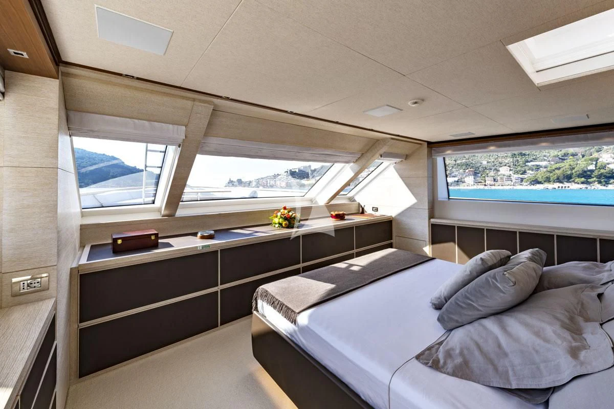 a room with a bed and a desk aboard ANYTHING GOES V Yacht for Sale