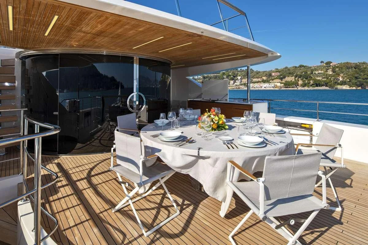 a table set for a meal on a boat aboard ANYTHING GOES V Yacht for Sale
