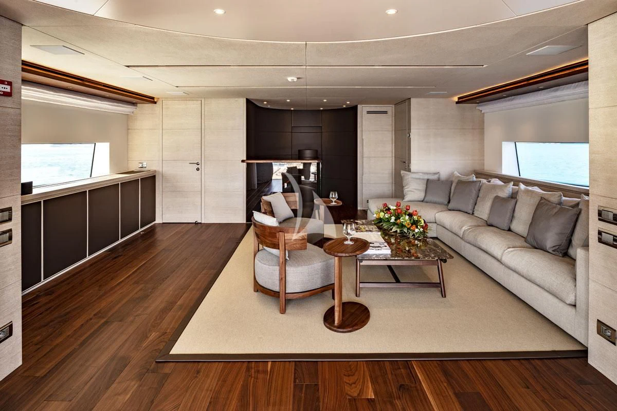 a living room with a couch and a coffee table aboard ANYTHING GOES V Yacht for Sale