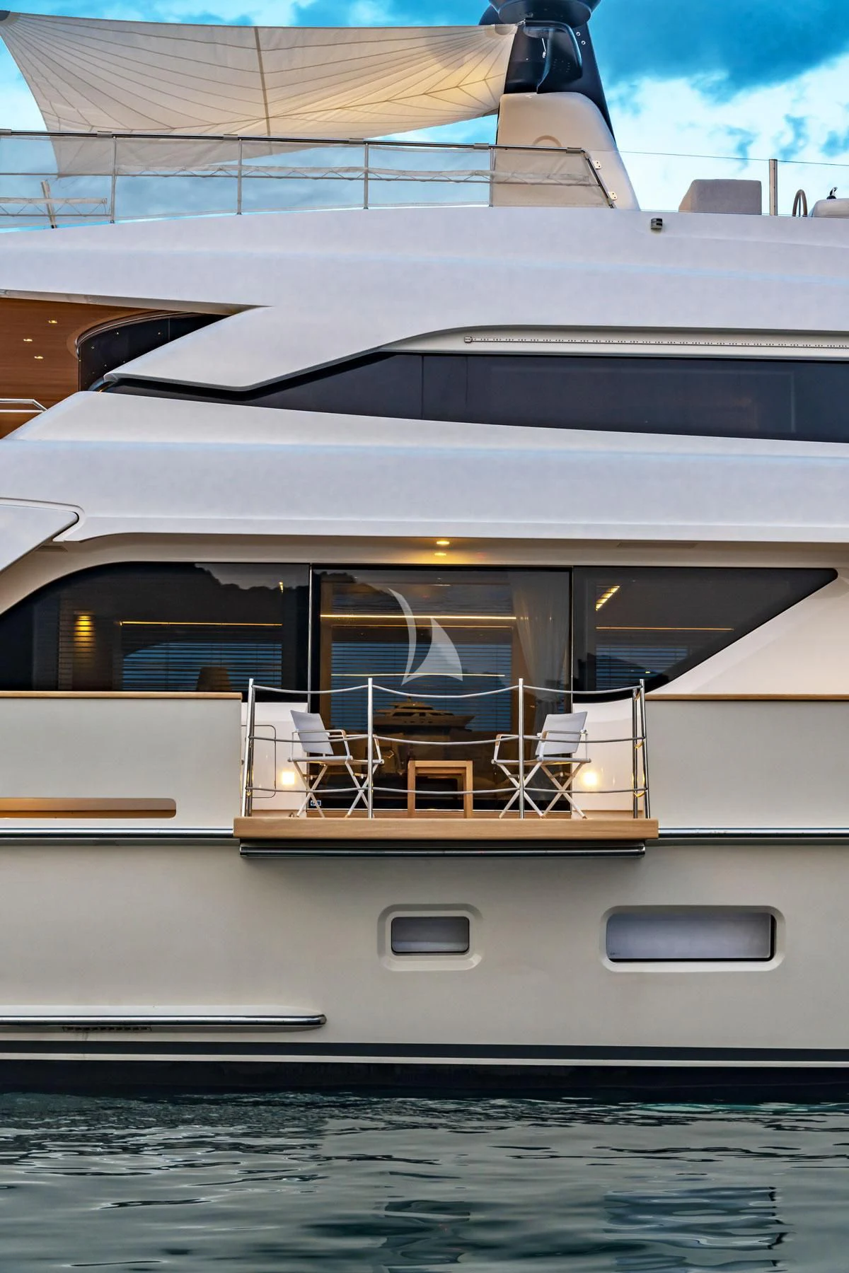 a boat with a deck and chairs on the deck aboard ANYTHING GOES V Yacht for Sale