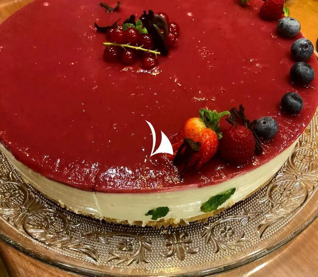 a cake with fruit on top aboard ANYTHING GOES V Yacht for Sale