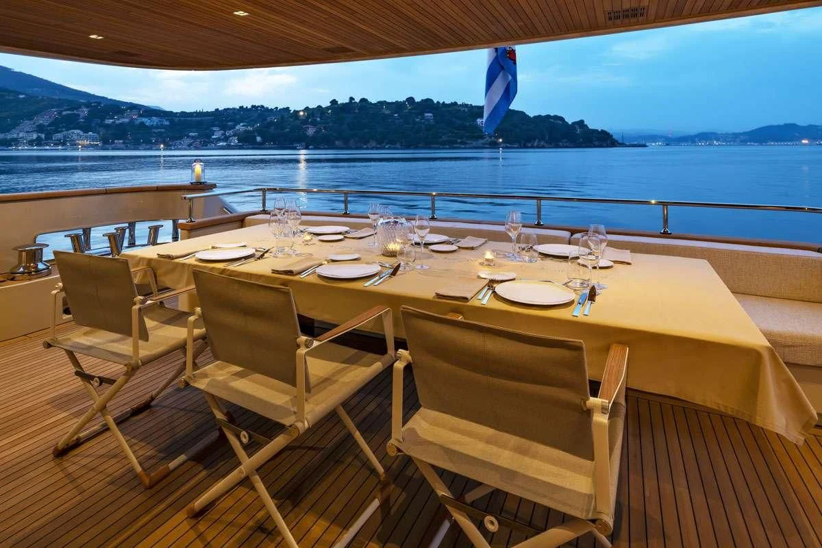 a table set for a dinner aboard ANYTHING GOES V Yacht for Sale