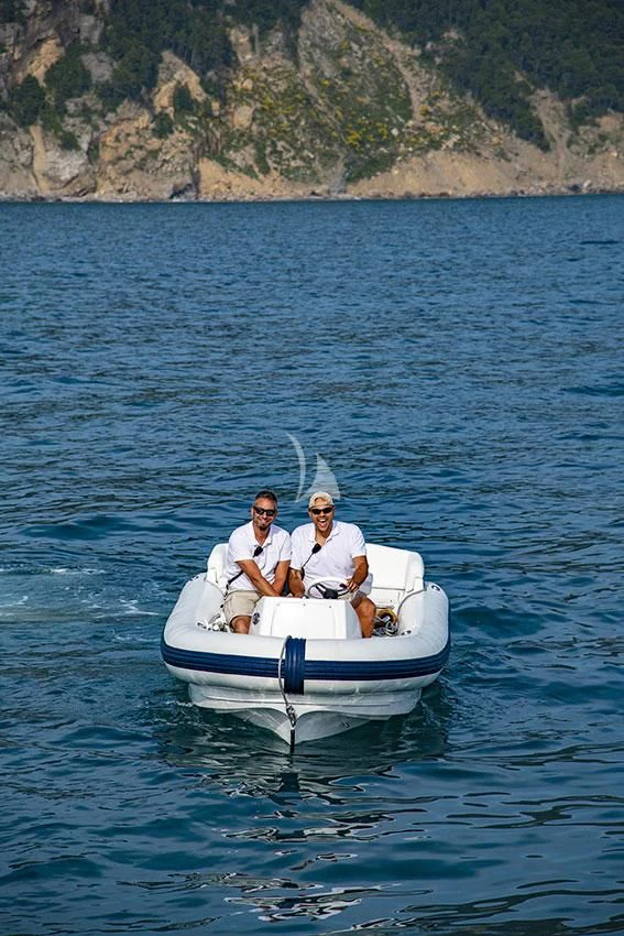 a couple of men in a boat aboard ANYTHING GOES V Yacht for Sale