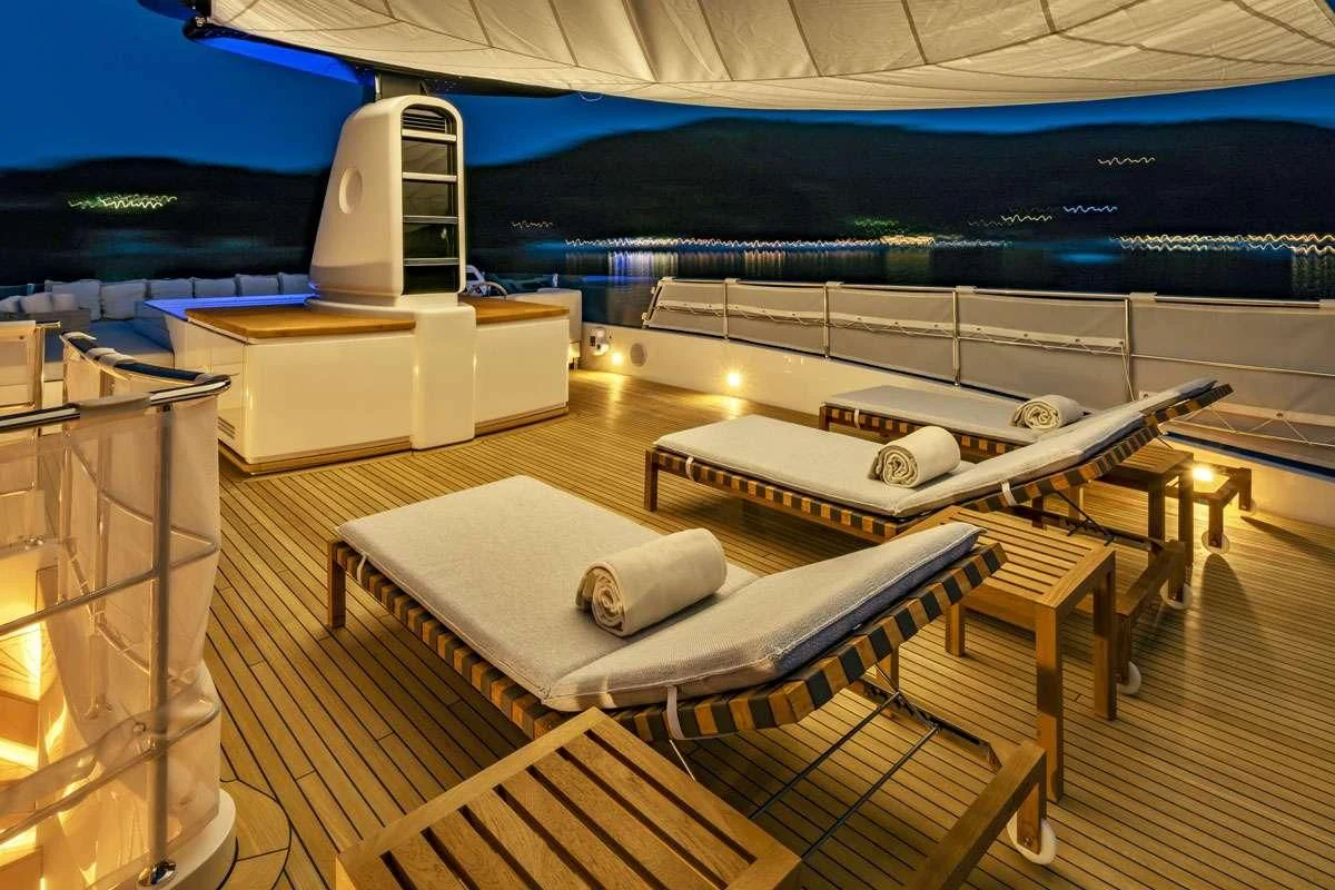 a bed on a deck aboard ANYTHING GOES V Yacht for Sale