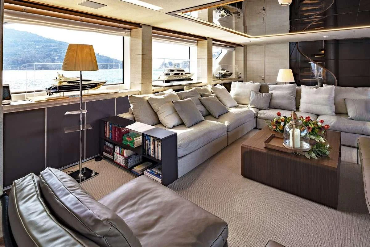 a living room with a couch and a coffee table aboard ANYTHING GOES V Yacht for Sale