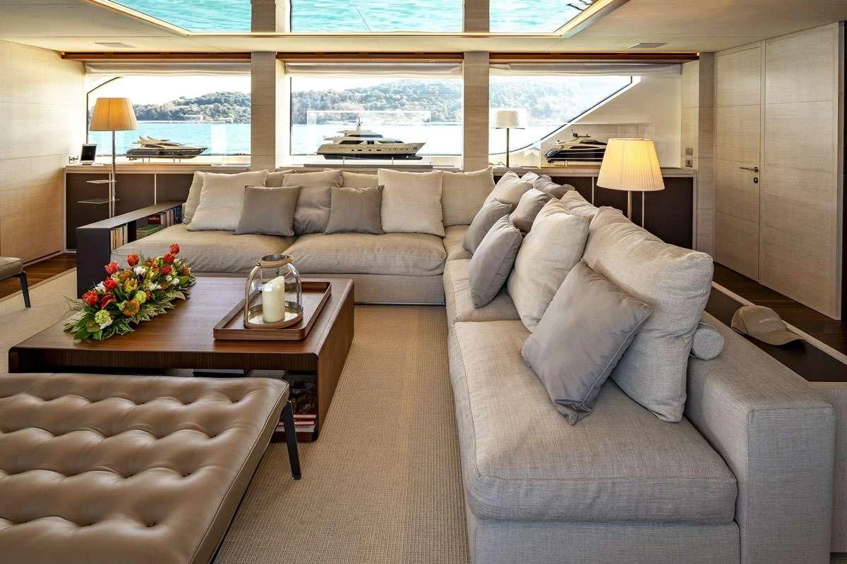 a living room with a couch and a table aboard ANYTHING GOES V Yacht for Sale