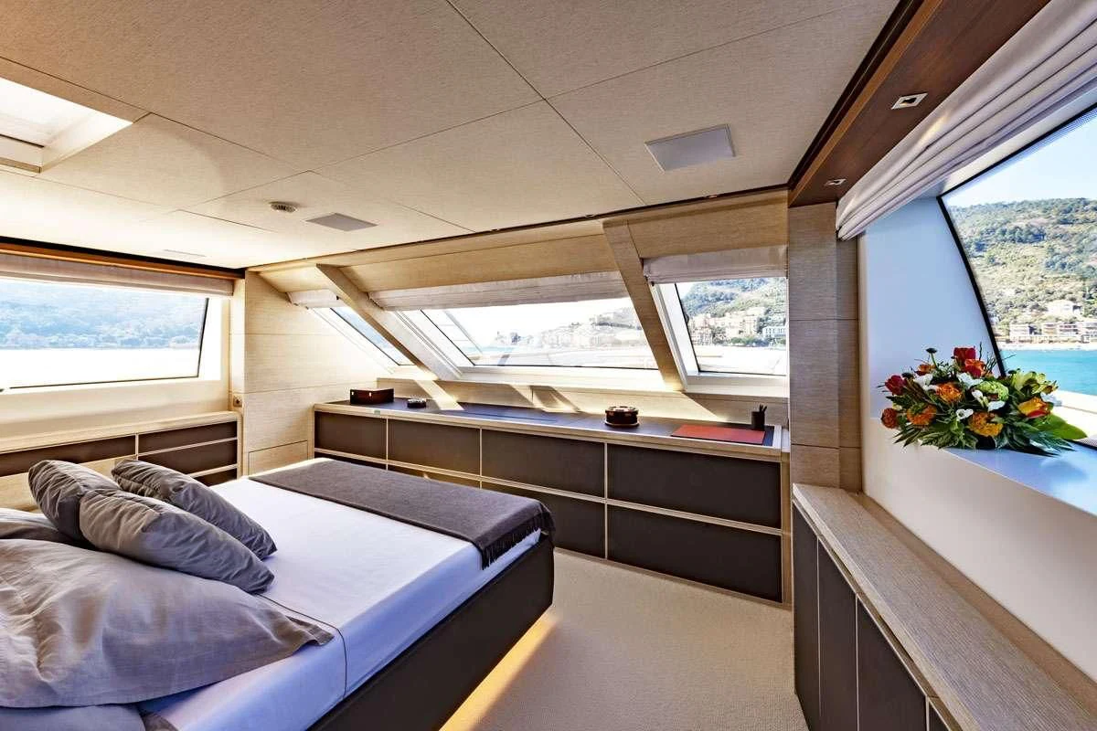 a room with a bed and a window aboard ANYTHING GOES V Yacht for Sale