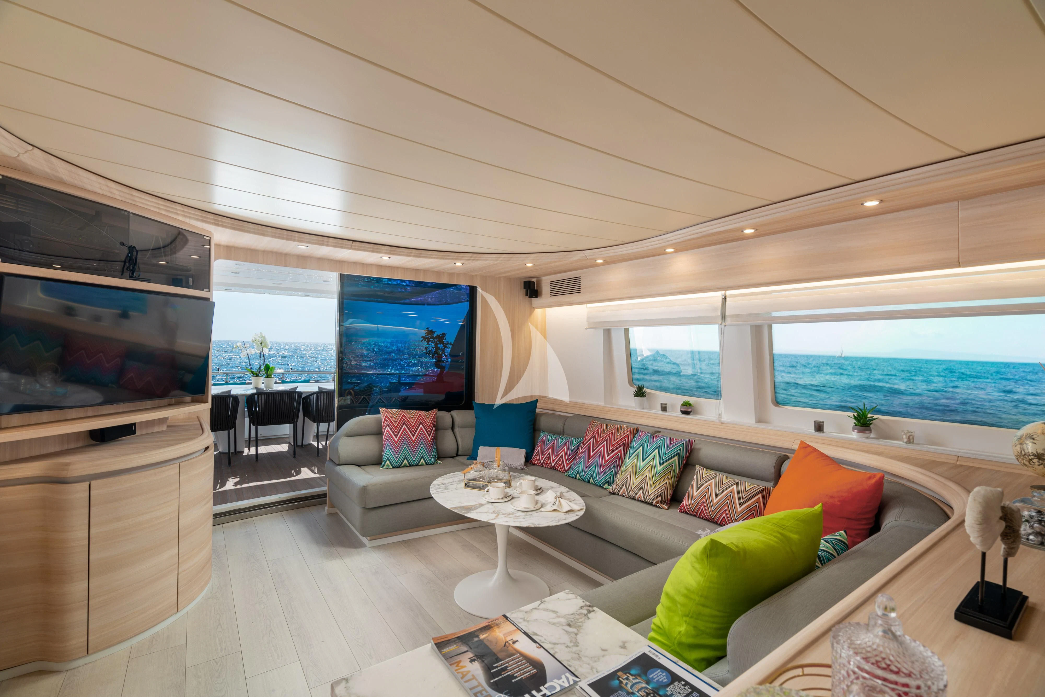 a living room with a large window aboard GEMINI 3 Yacht for Charter