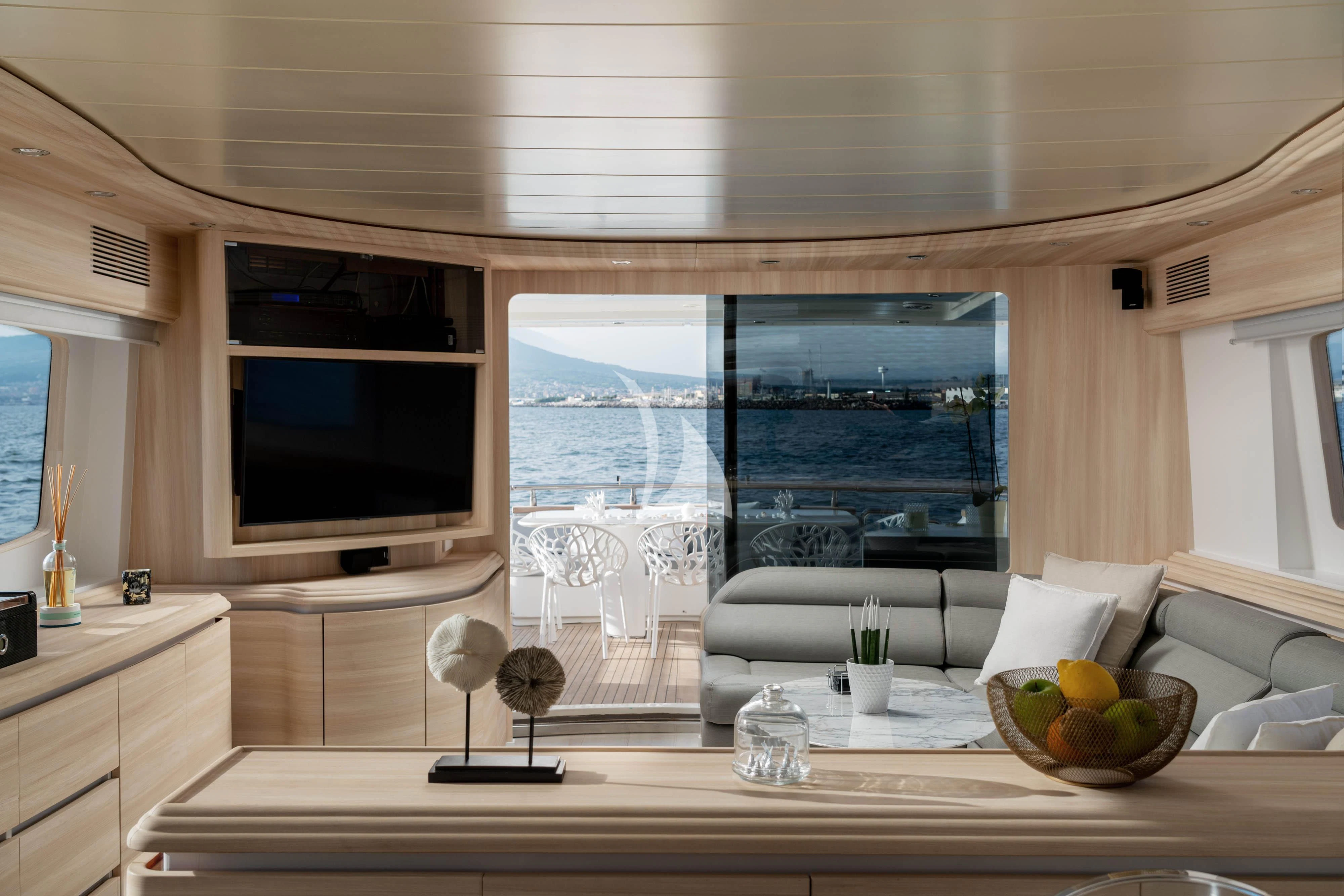 a living room with a large window aboard GEMINI 3 Yacht for Charter