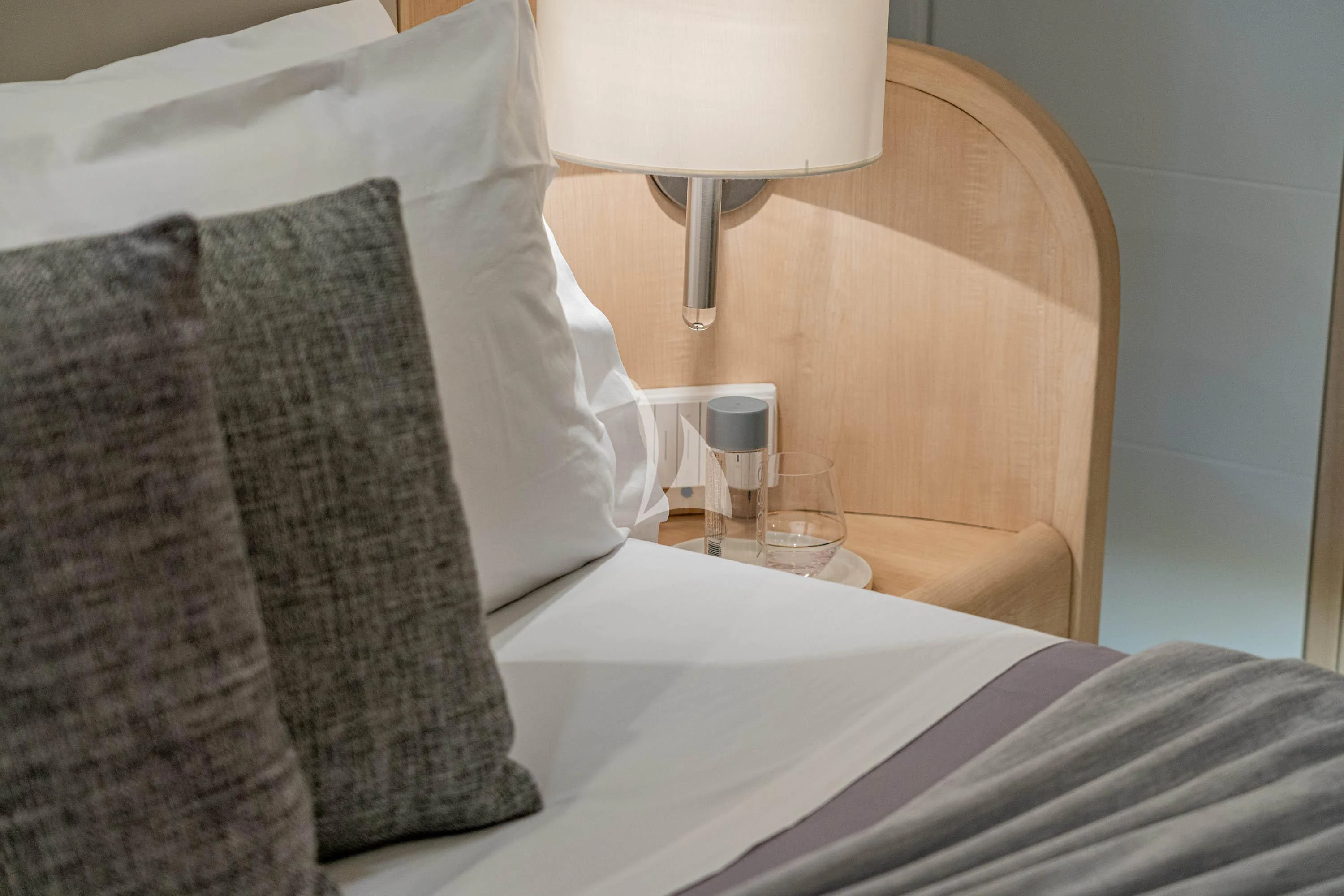a bed with pillows and a lamp aboard GEMINI 3 Yacht for Charter