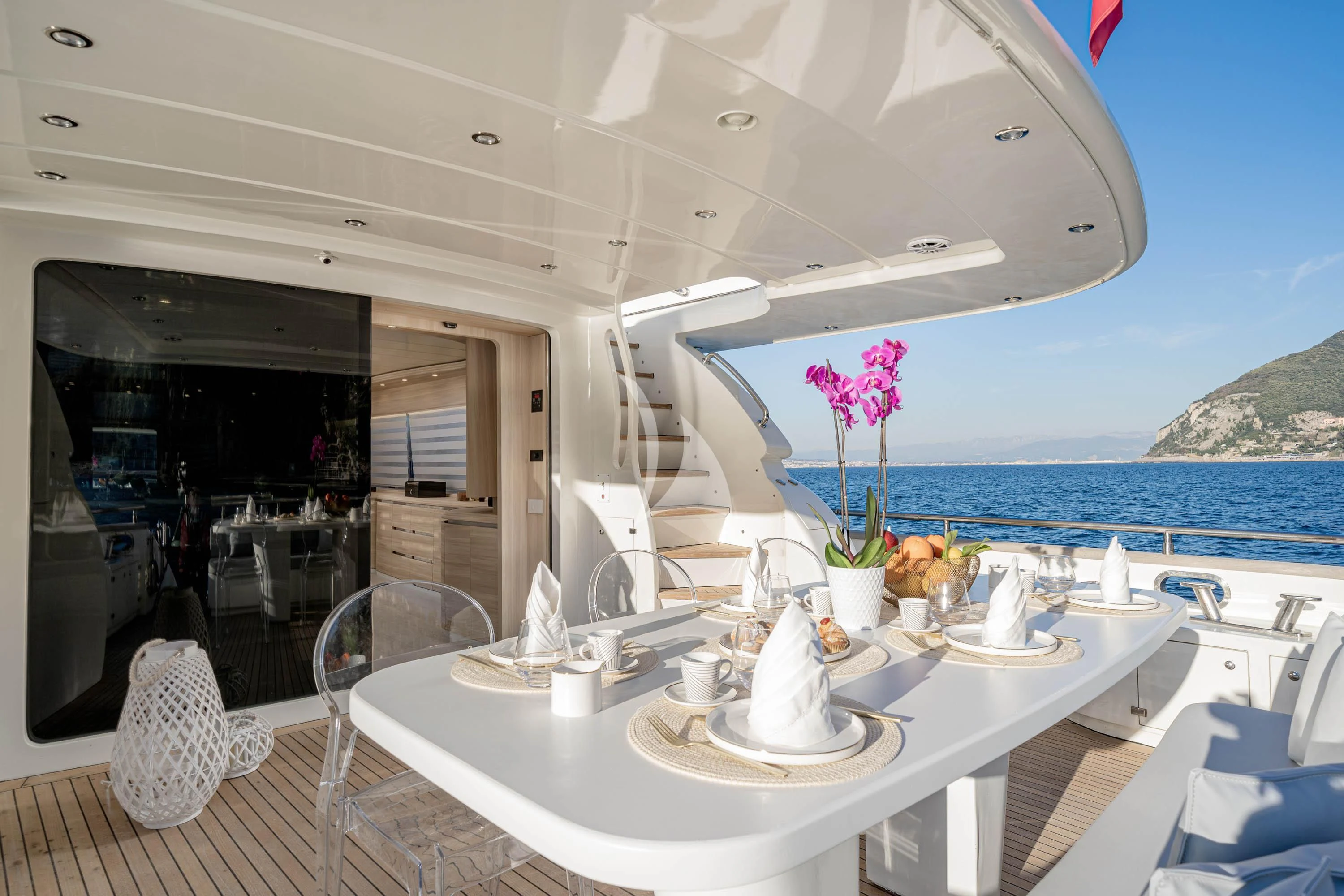 a table with chairs and a view of the ocean aboard GEMINI 3 Yacht for Charter
