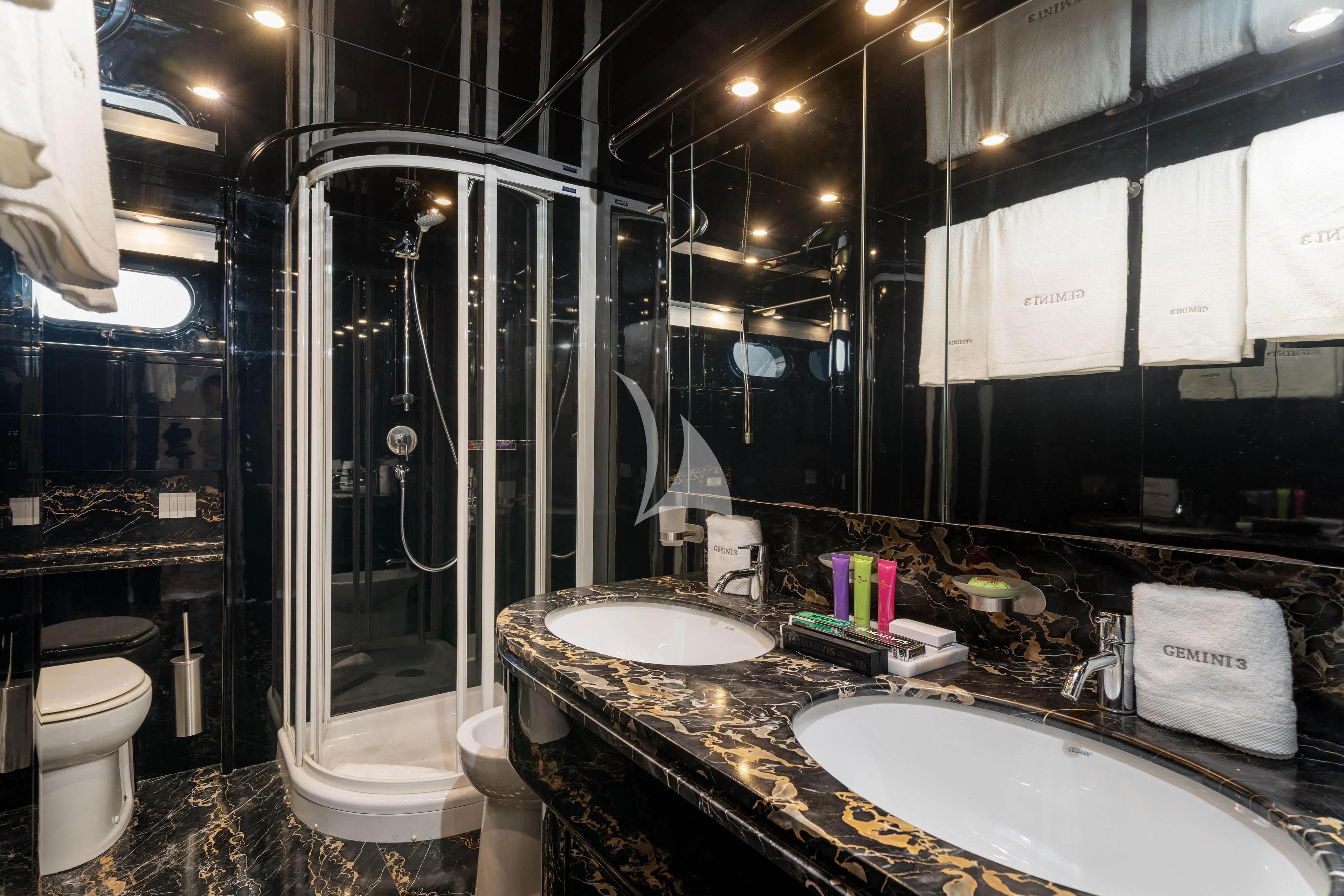 a bathroom with a shower and sinks aboard GEMINI 3 Yacht for Charter