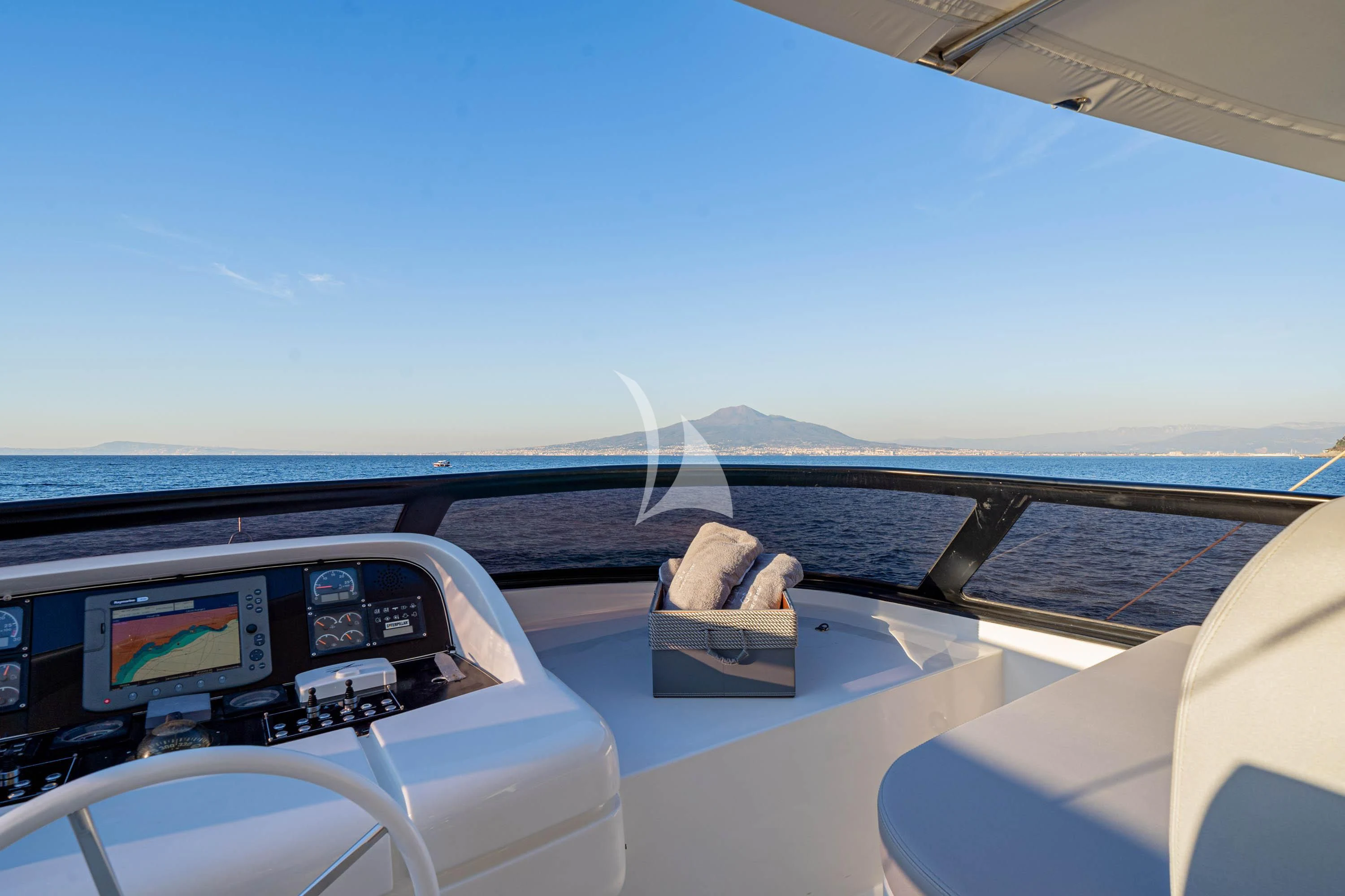 a boat with a view of the ocean and mountains aboard GEMINI 3 Yacht for Charter
