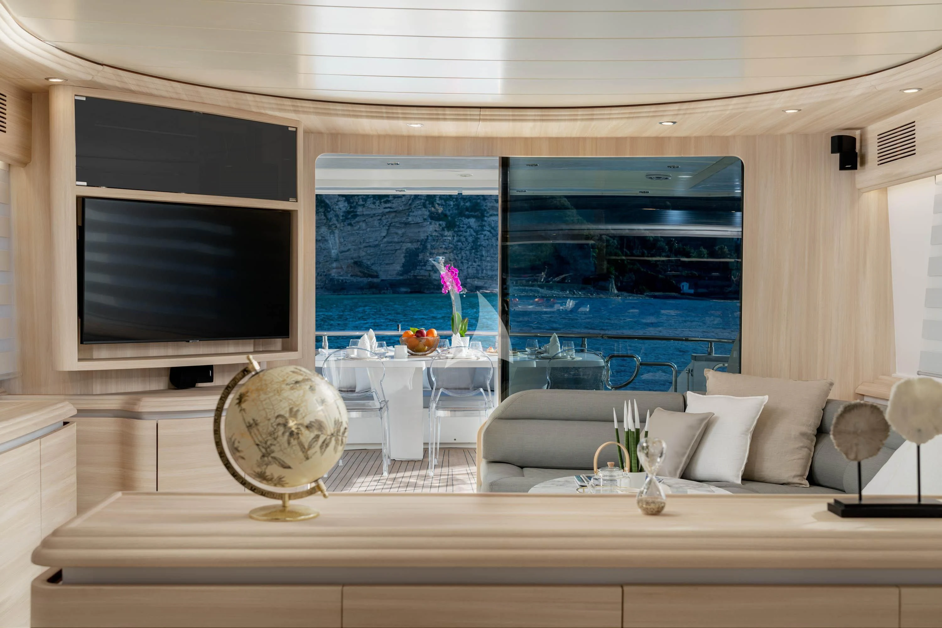 a living room with a large fireplace aboard GEMINI 3 Yacht for Charter