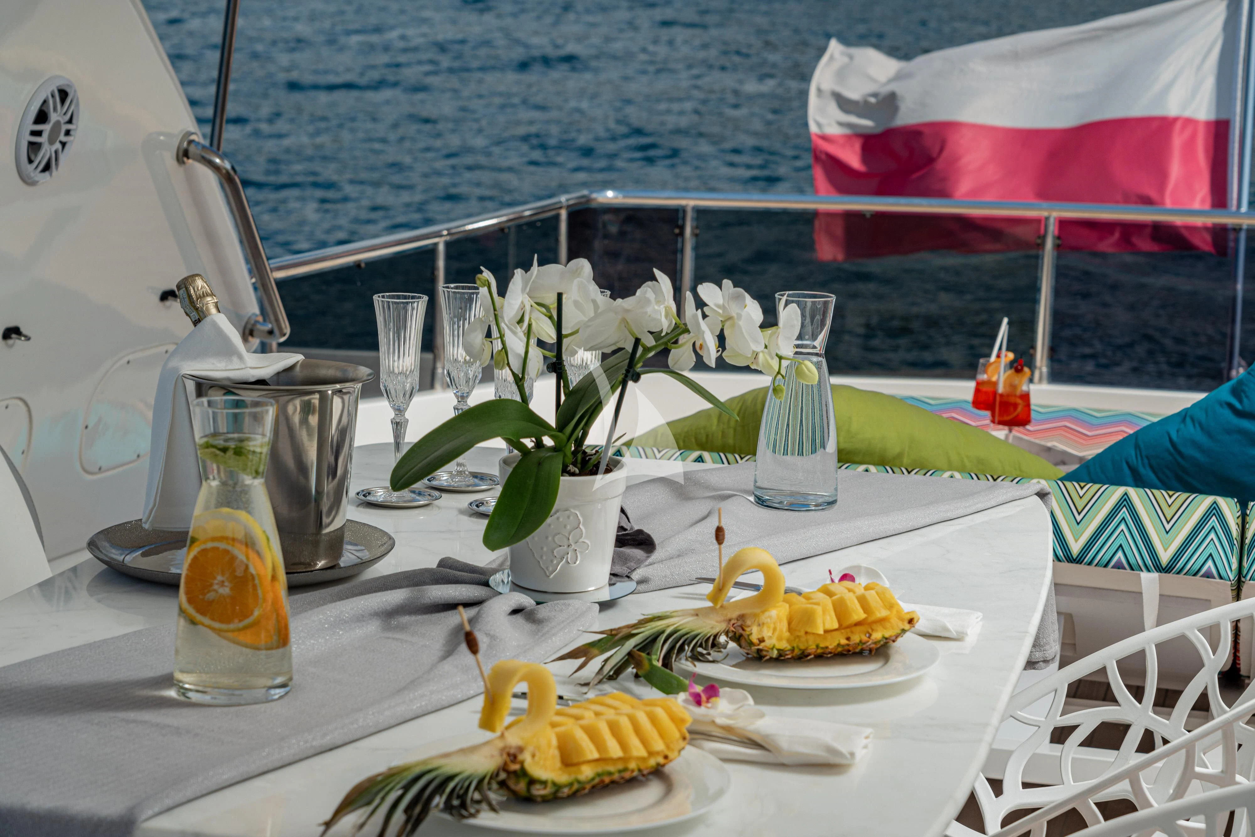 a table with food and drinks on it aboard GEMINI 3 Yacht for Charter