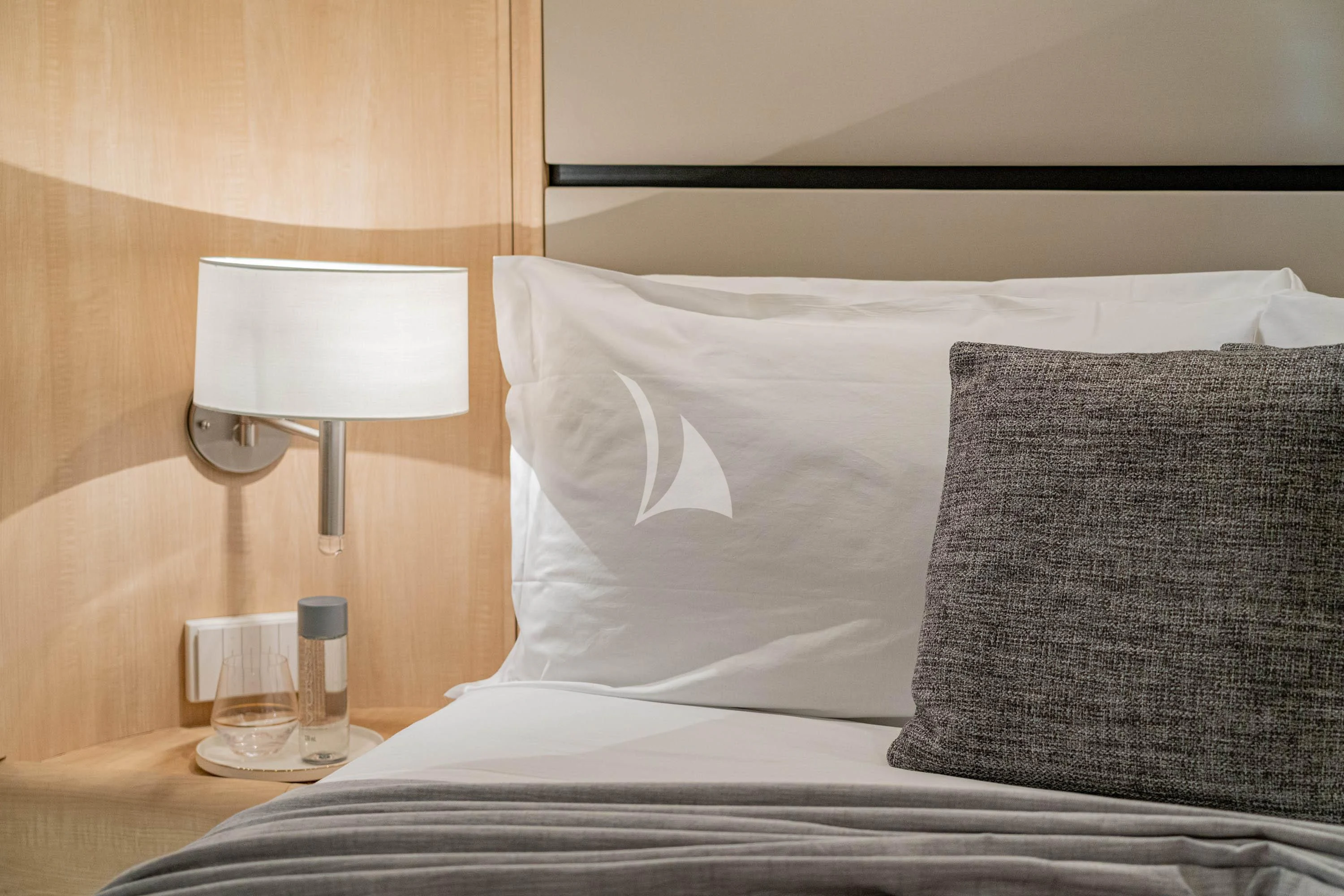 a bed with a lamp on it aboard GEMINI 3 Yacht for Charter
