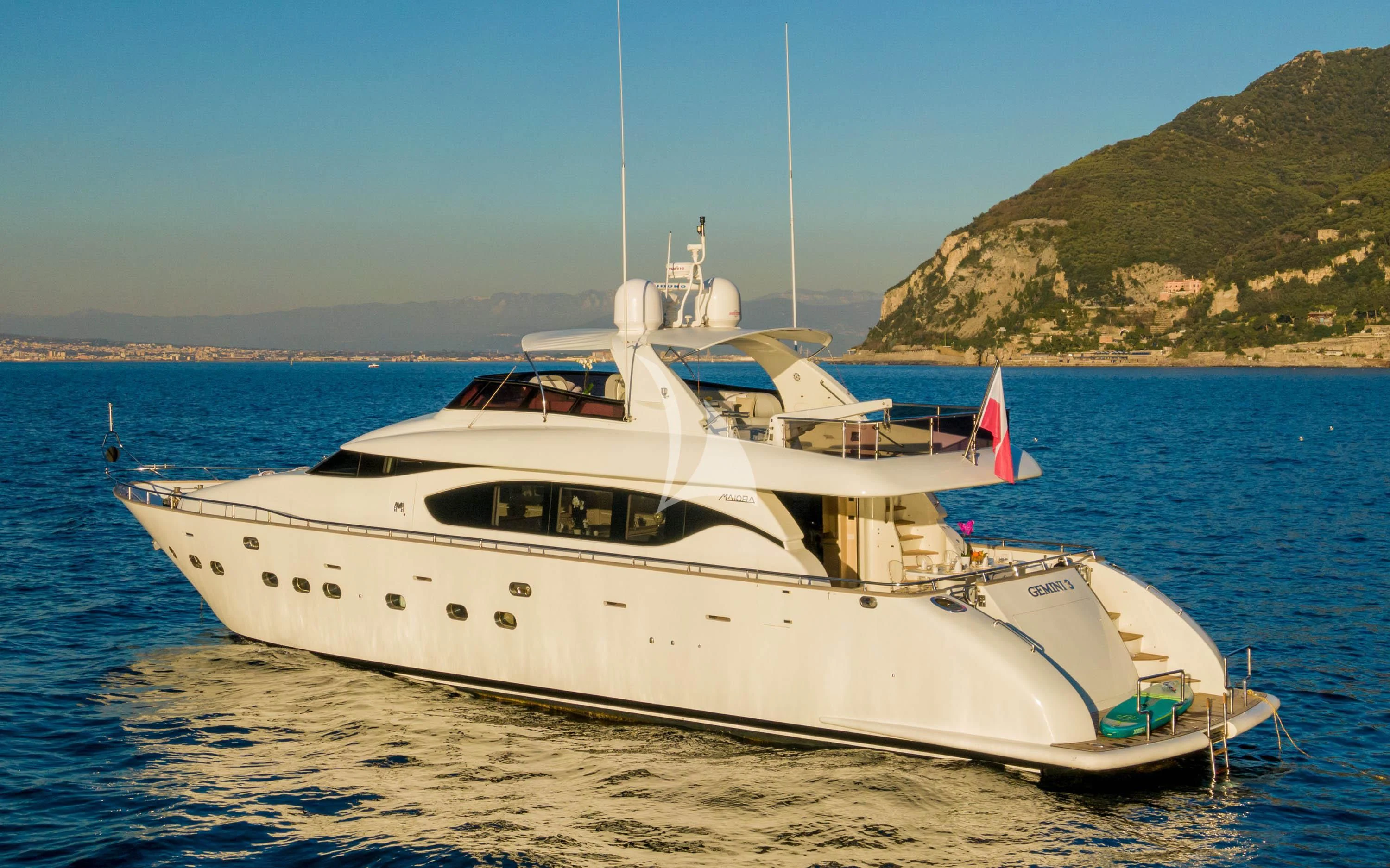 a white yacht on the beach aboard GEMINI 3 Yacht for Charter