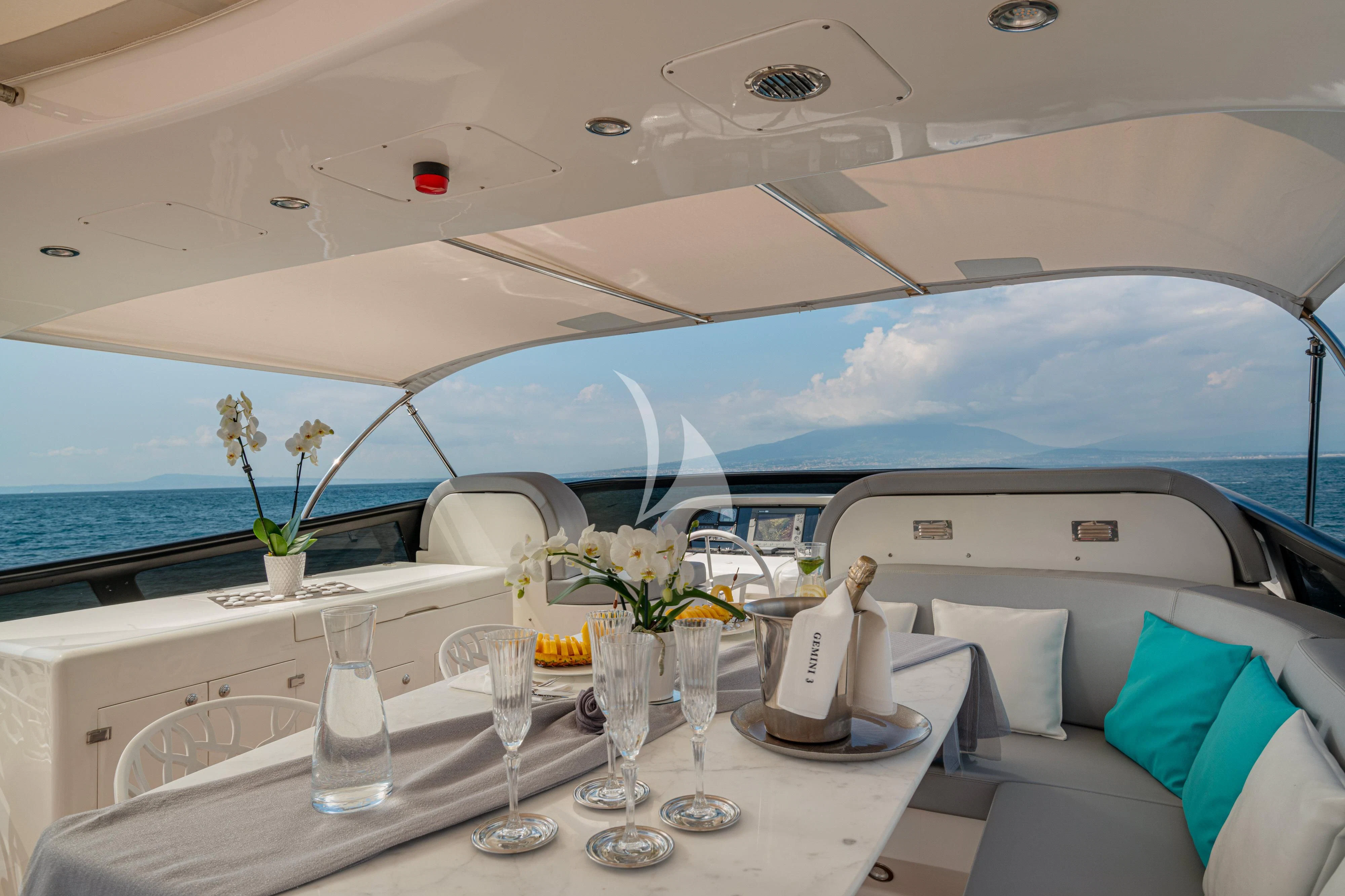 a yacht with a table and chairs aboard GEMINI 3 Yacht for Charter