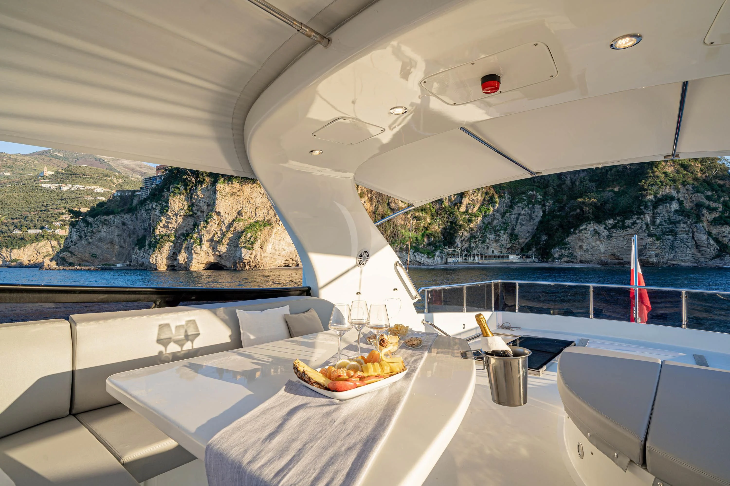 a table with a plate of food on it aboard GEMINI 3 Yacht for Charter