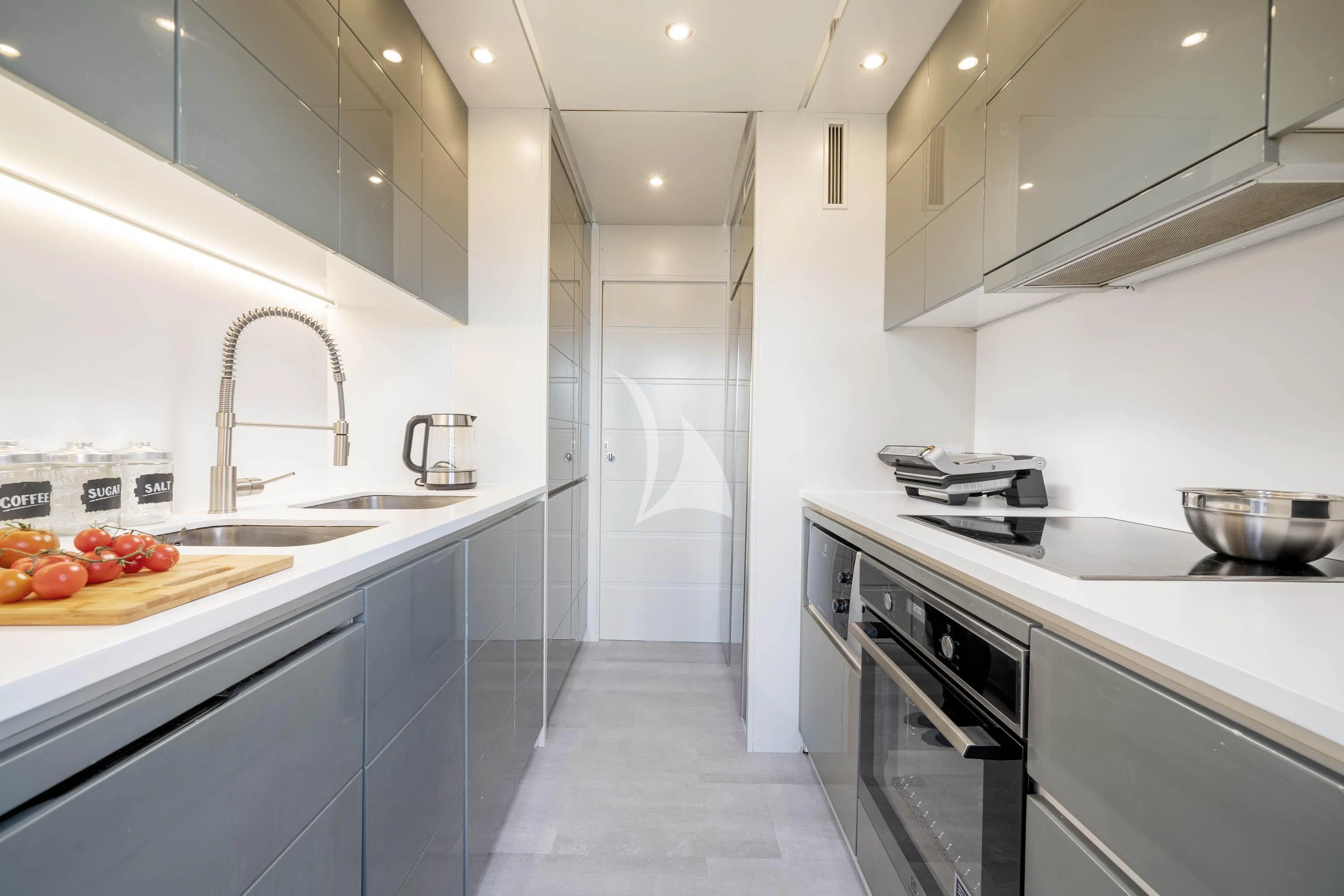 a kitchen with white cabinets aboard GEMINI 3 Yacht for Charter