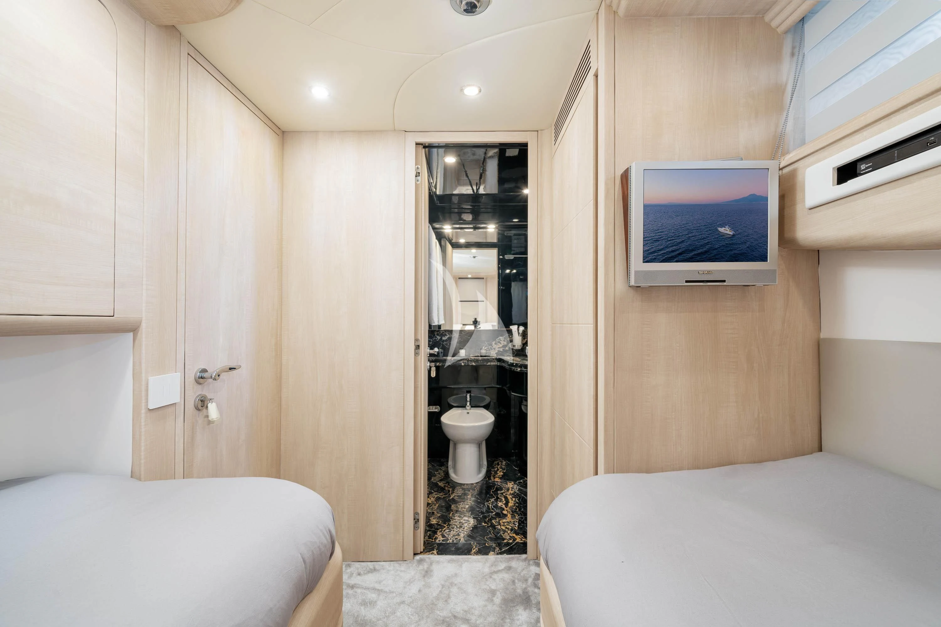 a small room with a bed and a television aboard GEMINI 3 Yacht for Charter