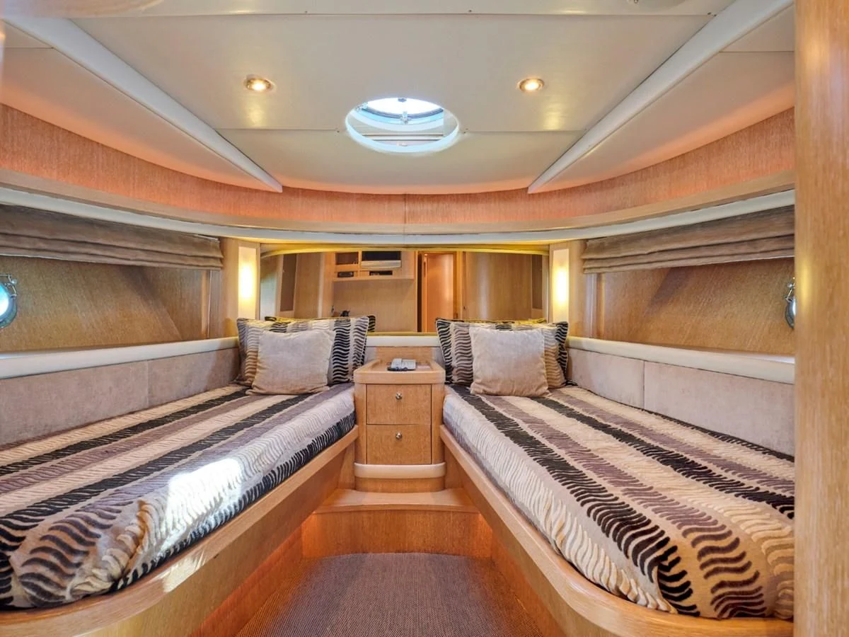 a room with a bed and a desk aboard HUNTING STAR Yacht for Sale