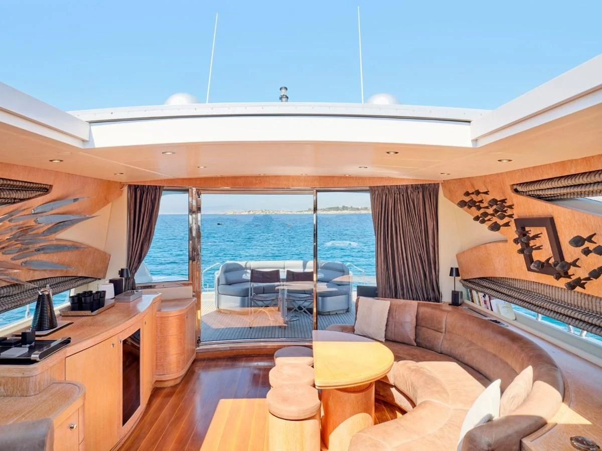 a room with a bed and a table and a view of the ocean aboard HUNTING STAR Yacht for Sale
