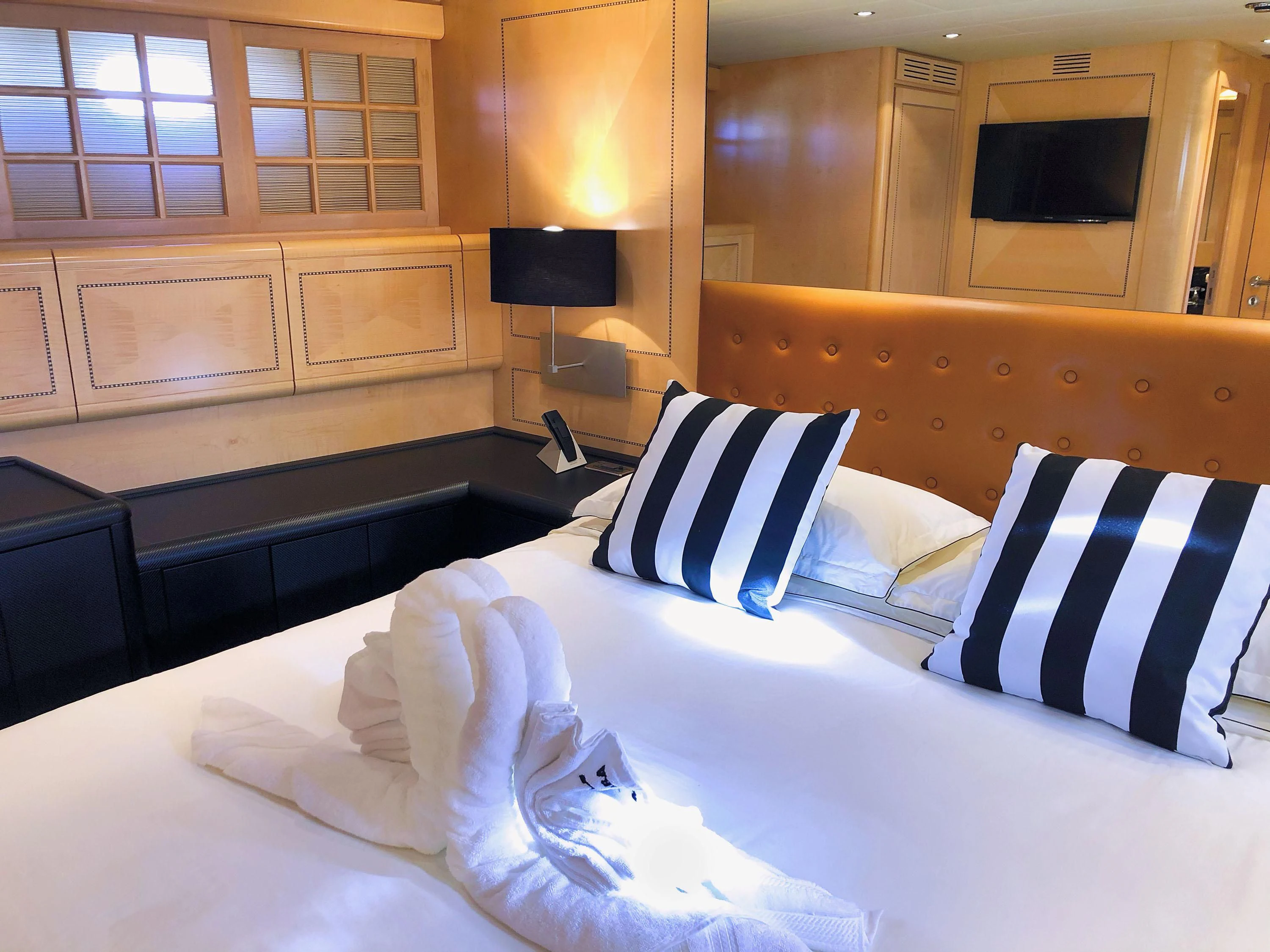 a bed with white sheets aboard EL PRIMERO Yacht for Sale