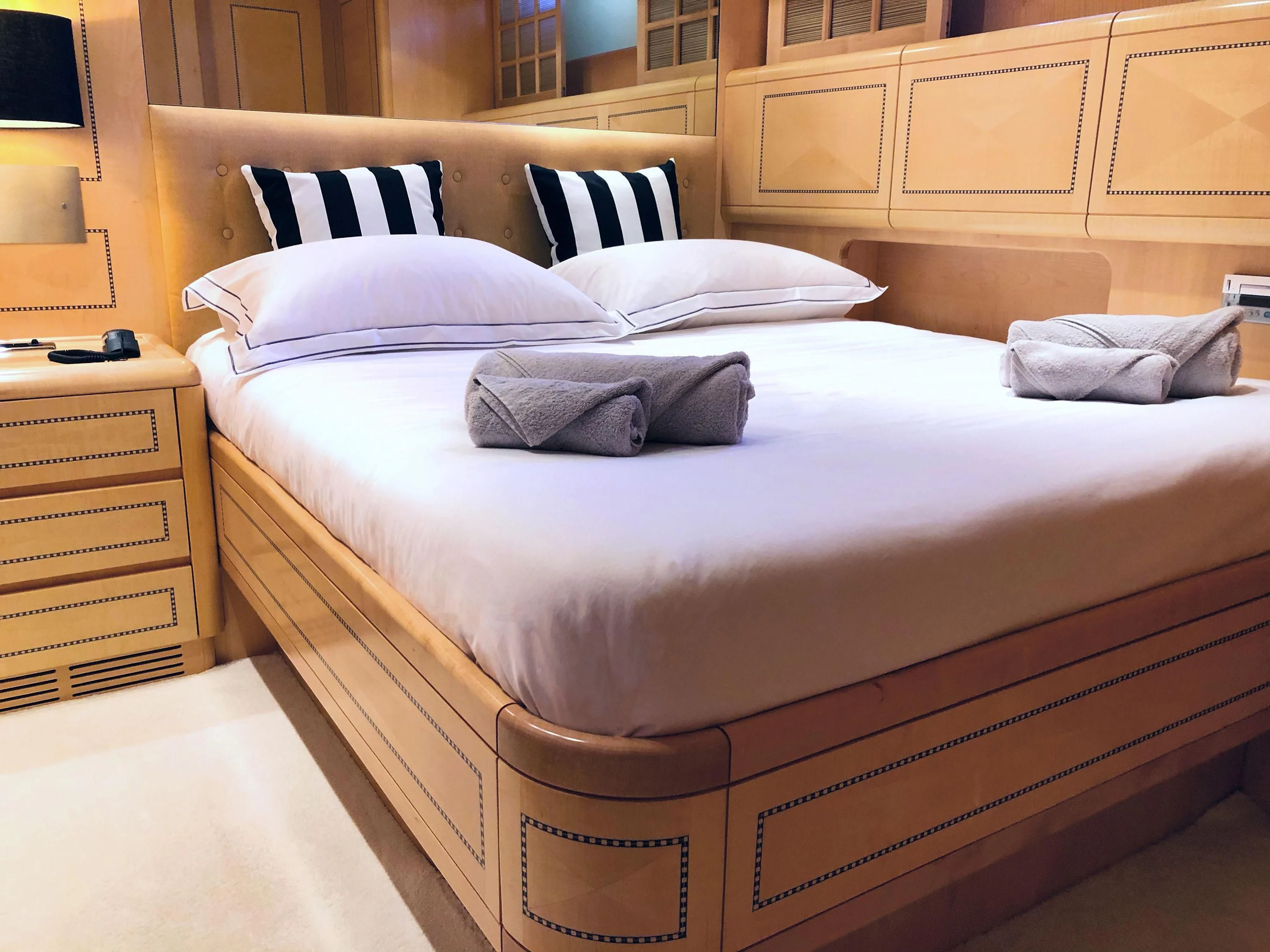 a bed with white sheets aboard EL PRIMERO Yacht for Sale
