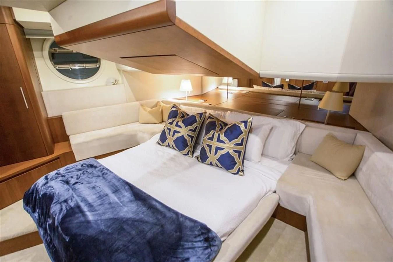 a bed with a blue blanket aboard BLUOCEAN Yacht for Sale