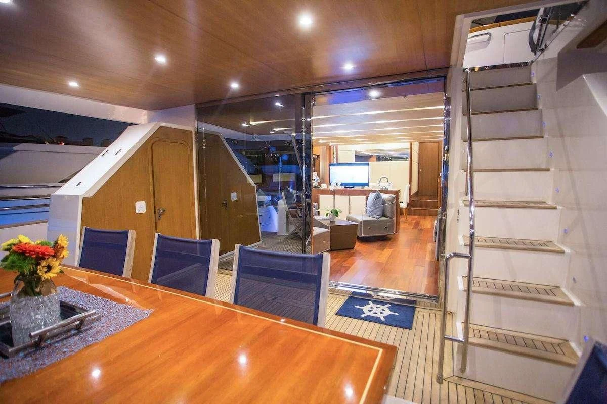 a room with a table and chairs aboard BLUOCEAN Yacht for Sale