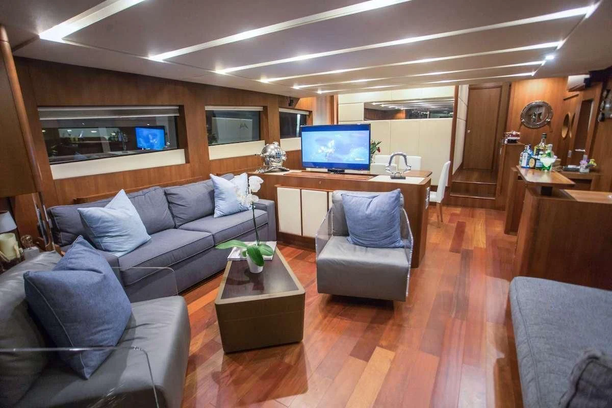 a living room with a couch and a tv aboard BLUOCEAN Yacht for Sale