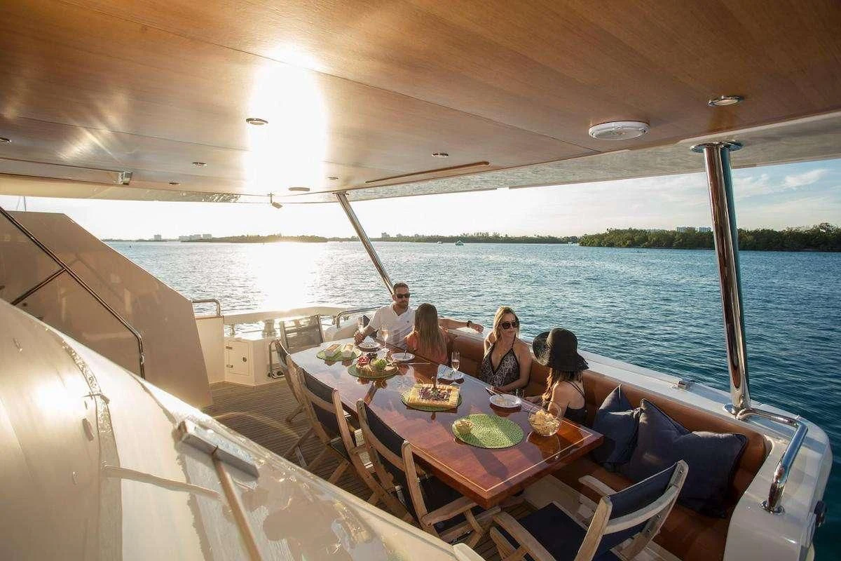 a group of people sitting at a table on a boat aboard BLUOCEAN Yacht for Sale