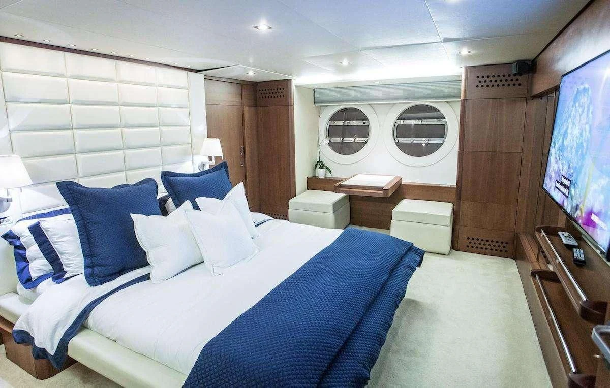 a room with a bed and a mirror aboard BLUOCEAN Yacht for Sale