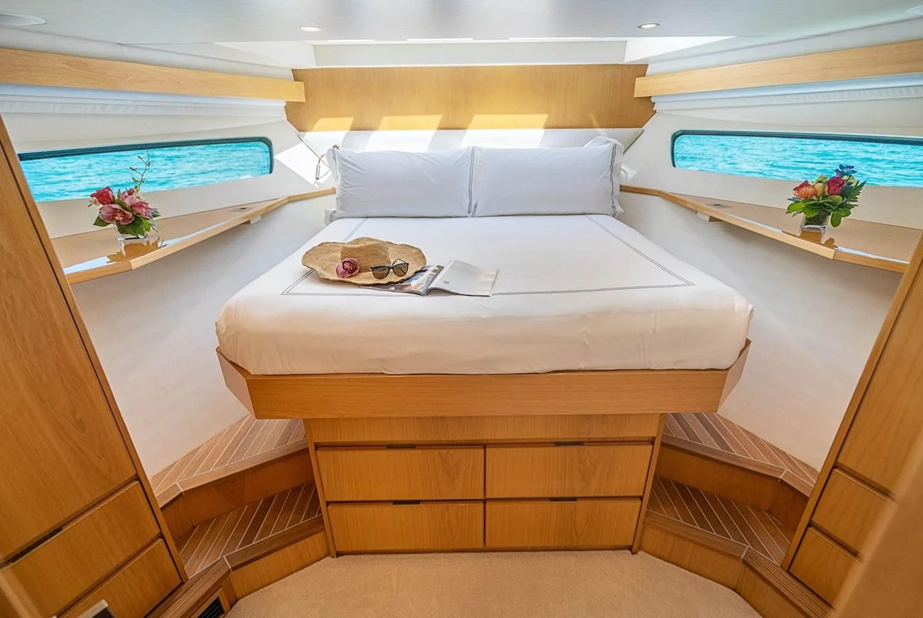 a bed with a white sheet and a white pillow on it aboard MARYBELLE Yacht for Sale