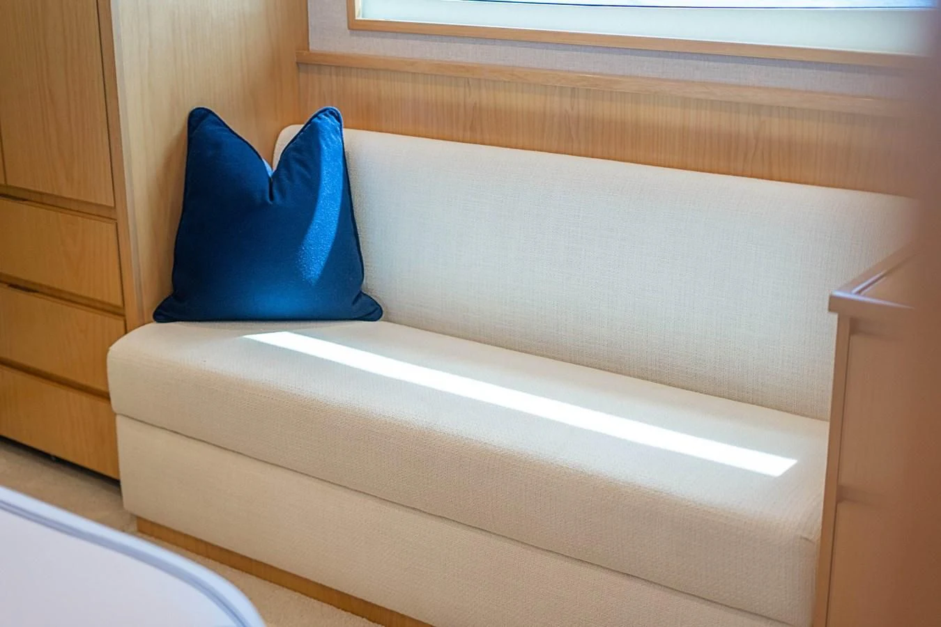 a blue pillow on a white couch aboard MARYBELLE Yacht for Sale