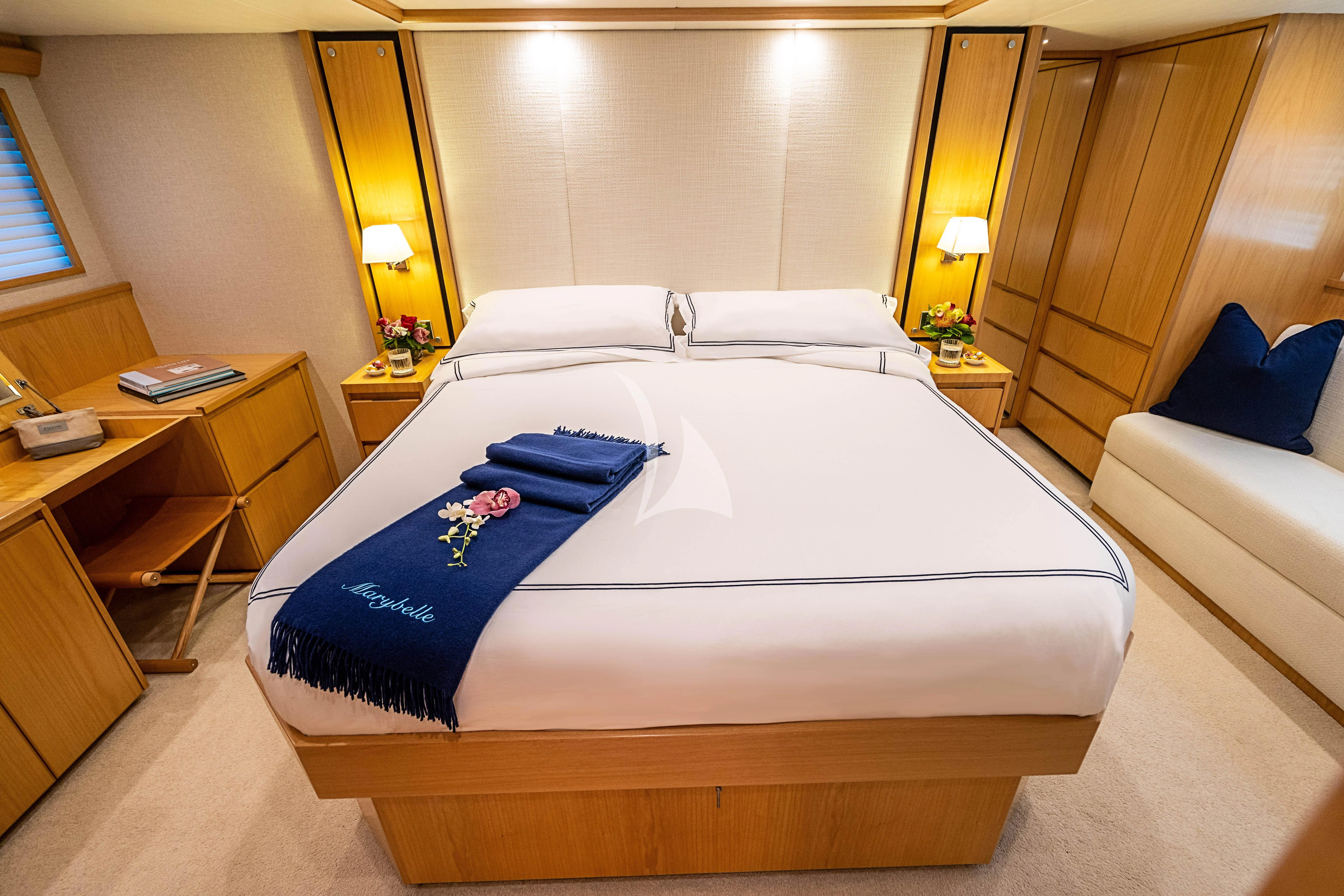 a hotel room with a bed and desk aboard MARYBELLE Yacht for Sale