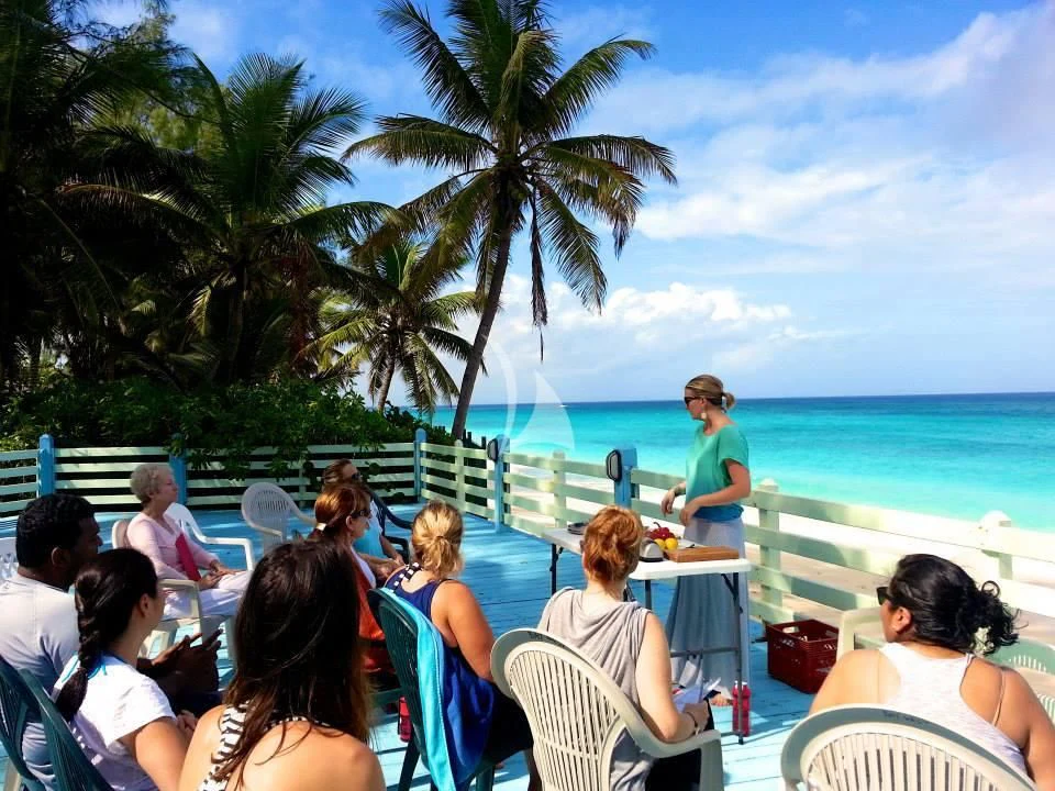 people sitting on a beach aboard MARYBELLE Yacht for Sale