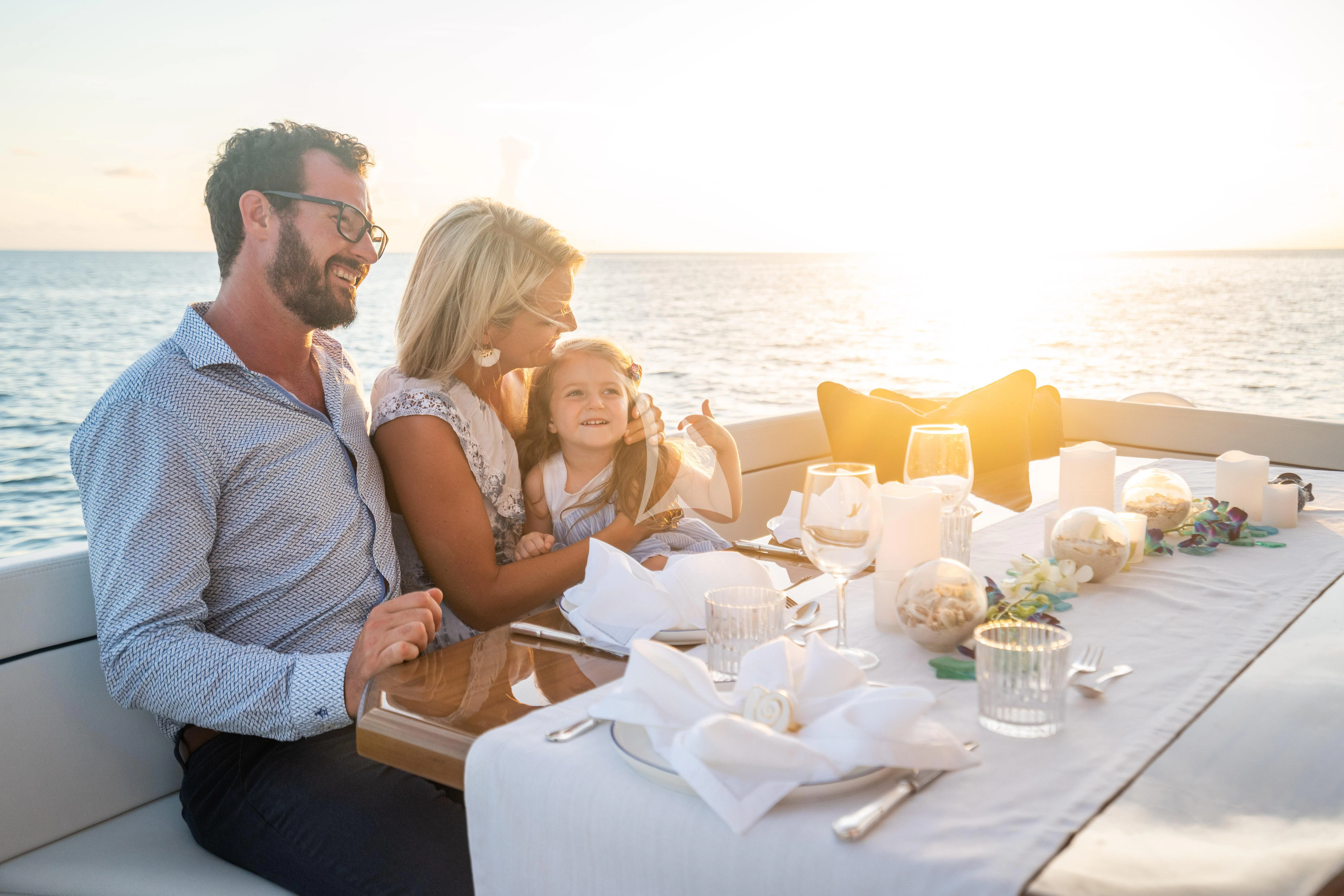 a family sitting at a table aboard MARYBELLE Yacht for Sale