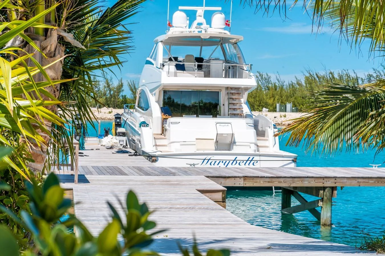 a white boat in a tropical area aboard MARYBELLE Yacht for Sale