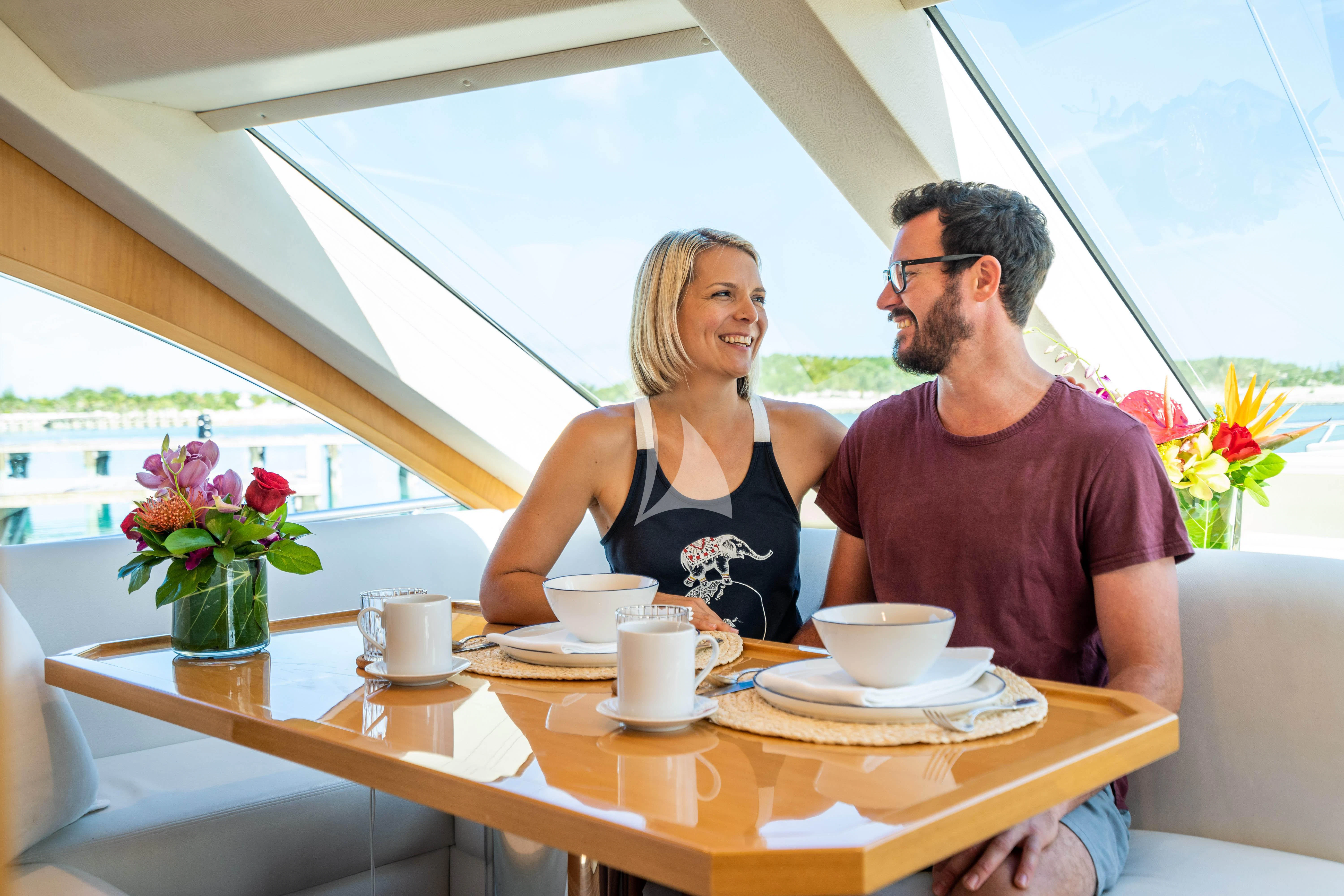 a group of people sitting at a table with coffee cups and saucers aboard MARYBELLE Yacht for Sale