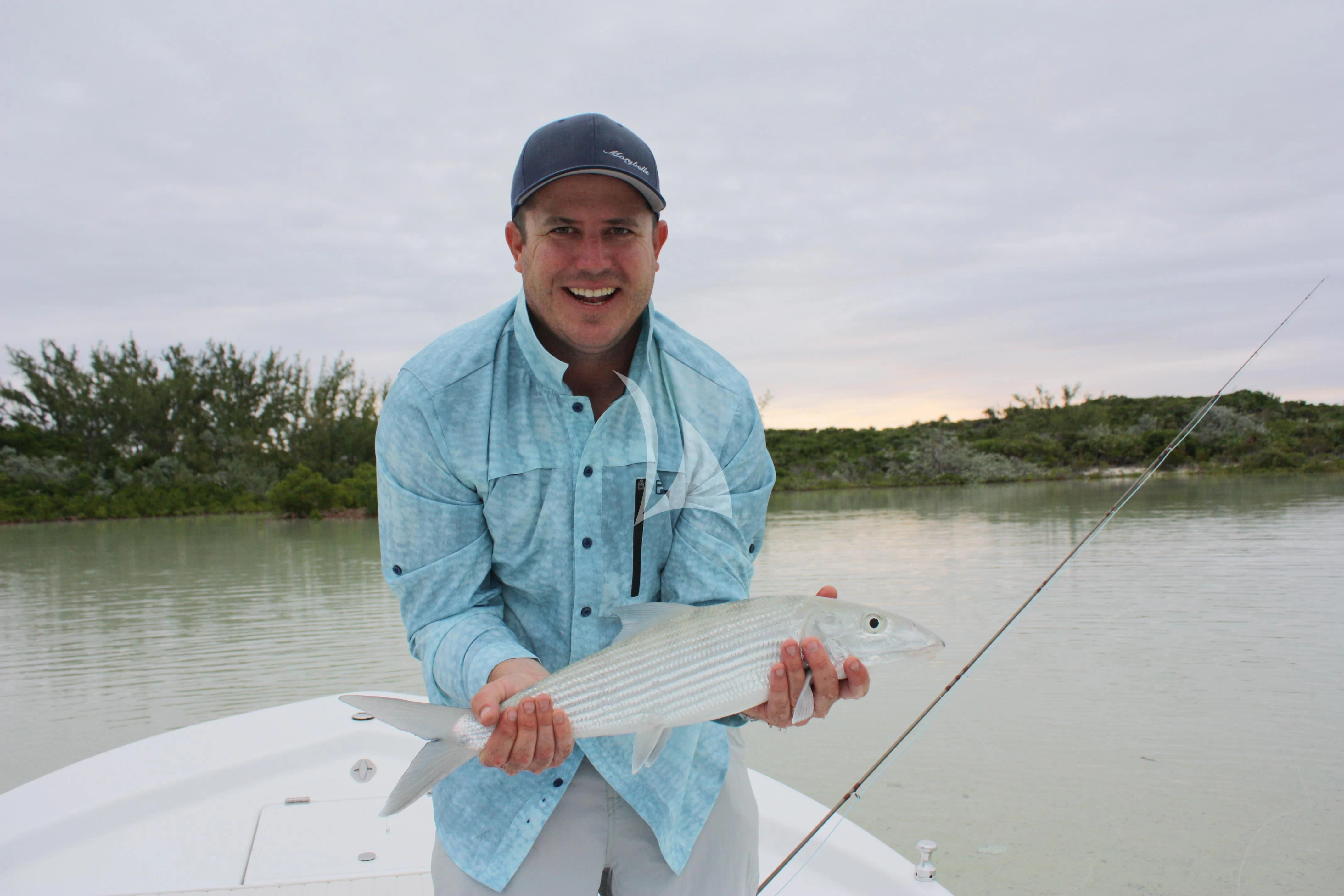 a man holding a fish aboard MARYBELLE Yacht for Sale