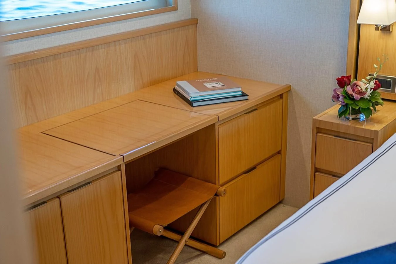 a desk with a book and a lamp on it aboard MARYBELLE Yacht for Sale