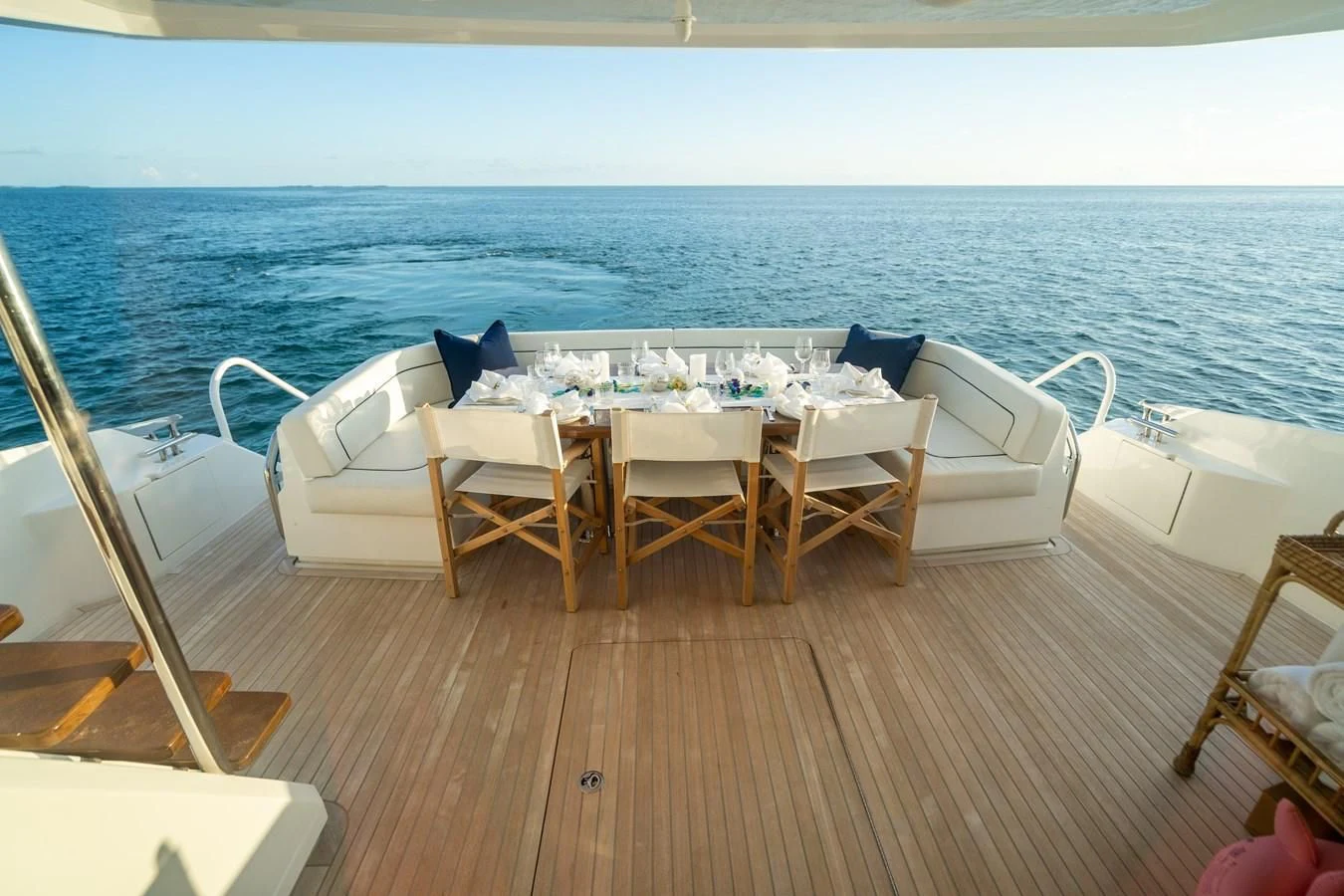 a table and chairs on a deck overlooking the ocean aboard MARYBELLE Yacht for Sale