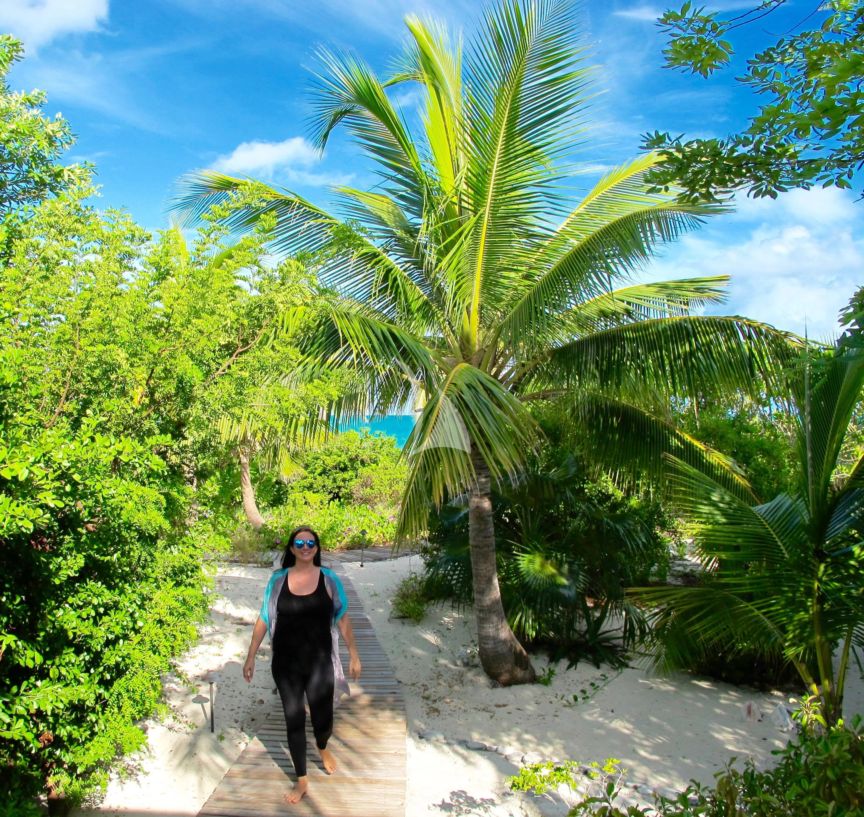 a person walking on a path with trees and blue sky aboard MARYBELLE Yacht for Sale