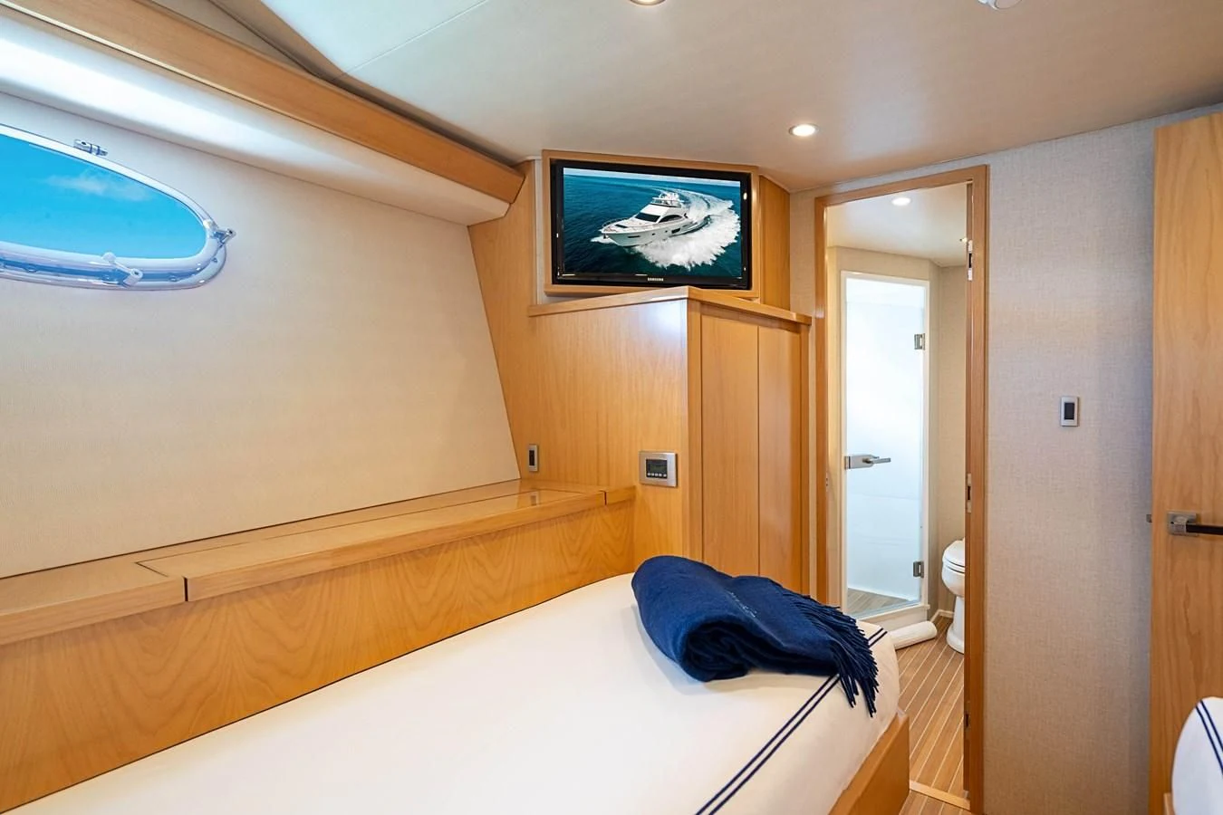 a bedroom with a bed and a television on the wall aboard MARYBELLE Yacht for Sale