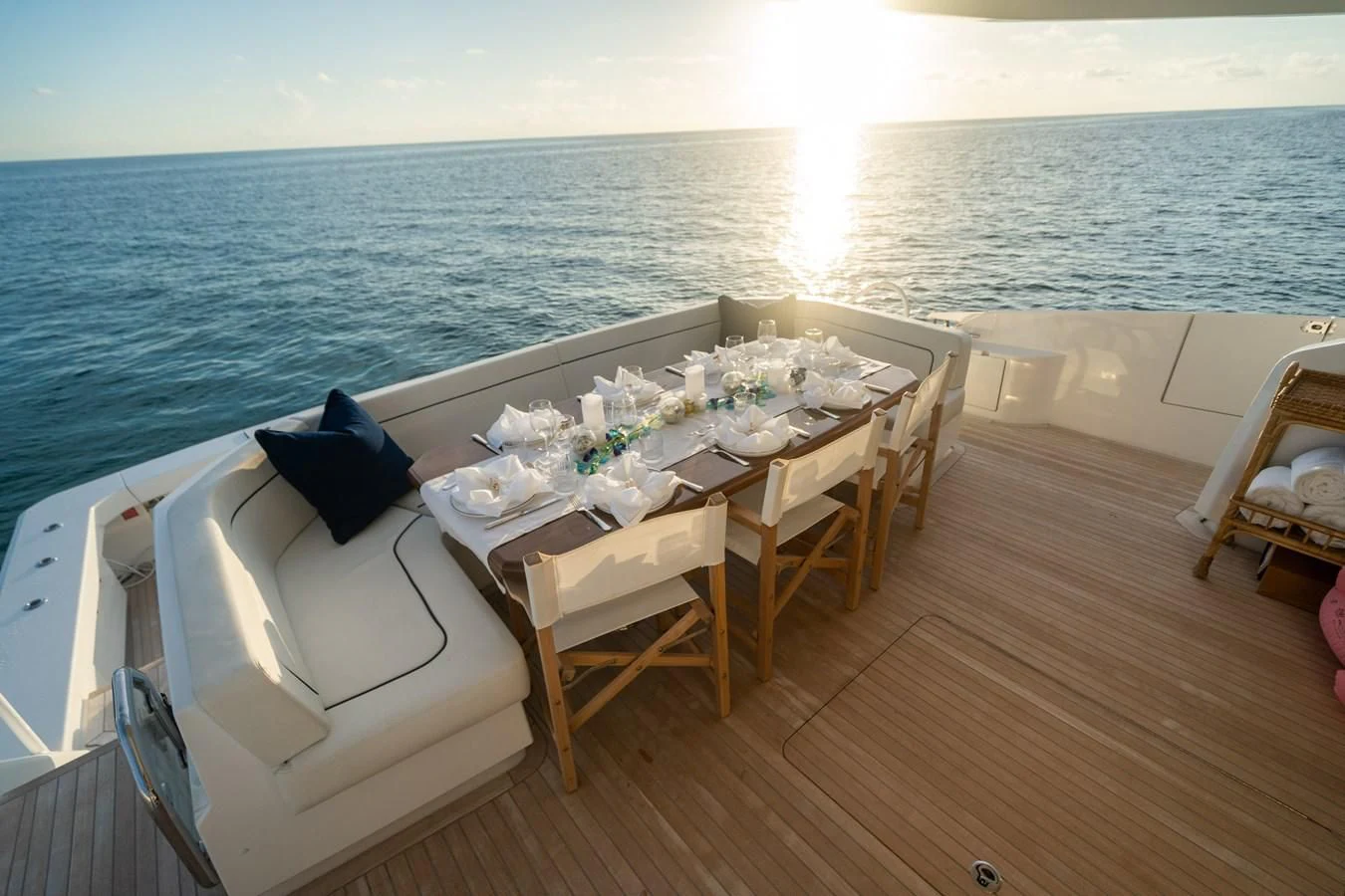 a table with chairs on a deck overlooking the ocean aboard MARYBELLE Yacht for Sale