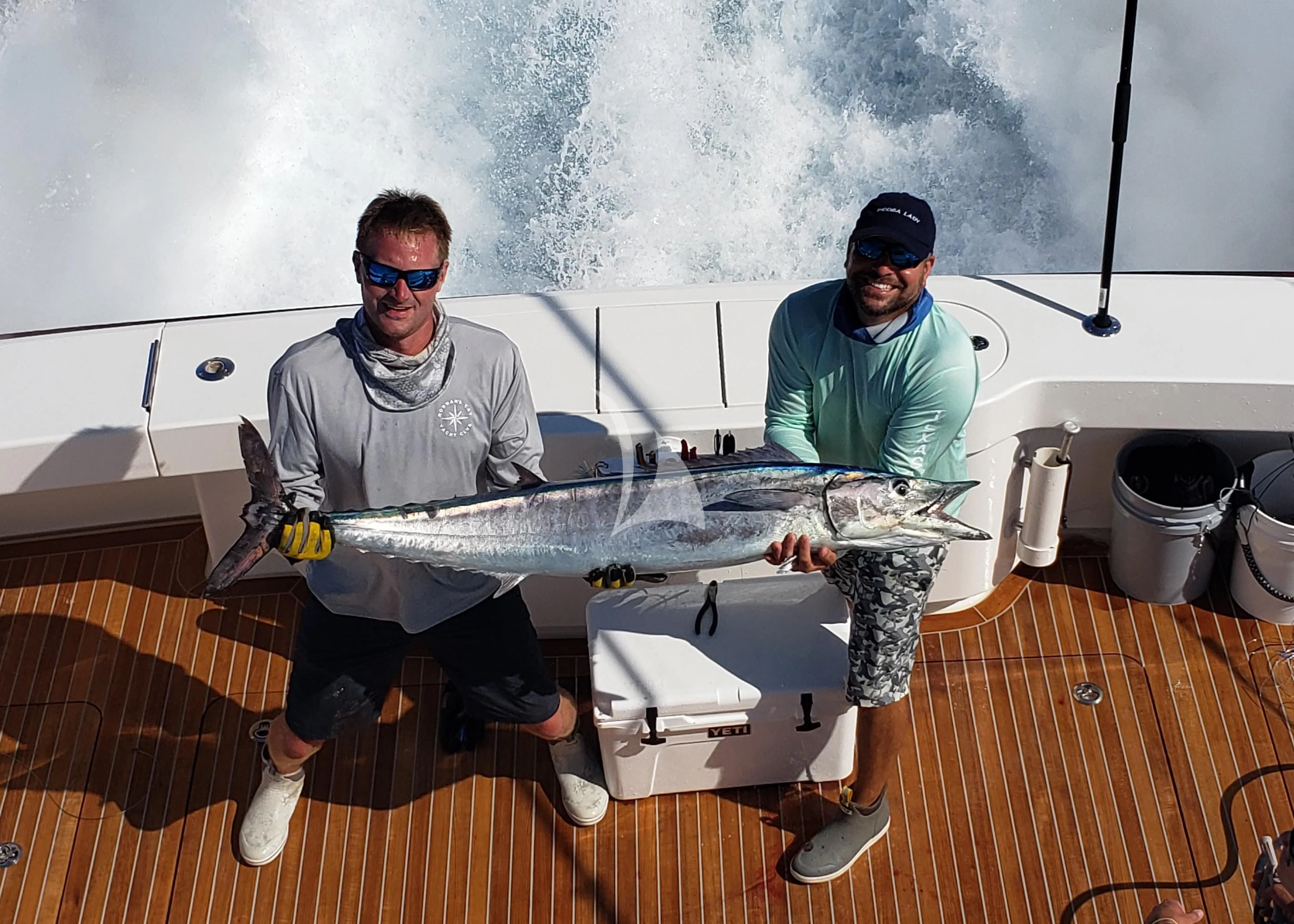 a couple of men holding a fish aboard MARYBELLE Yacht for Sale